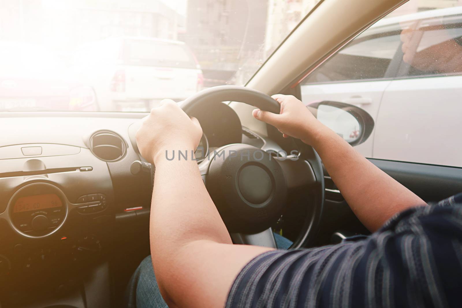 Man driving with both hands on steering wheel selective focus. s by peandben