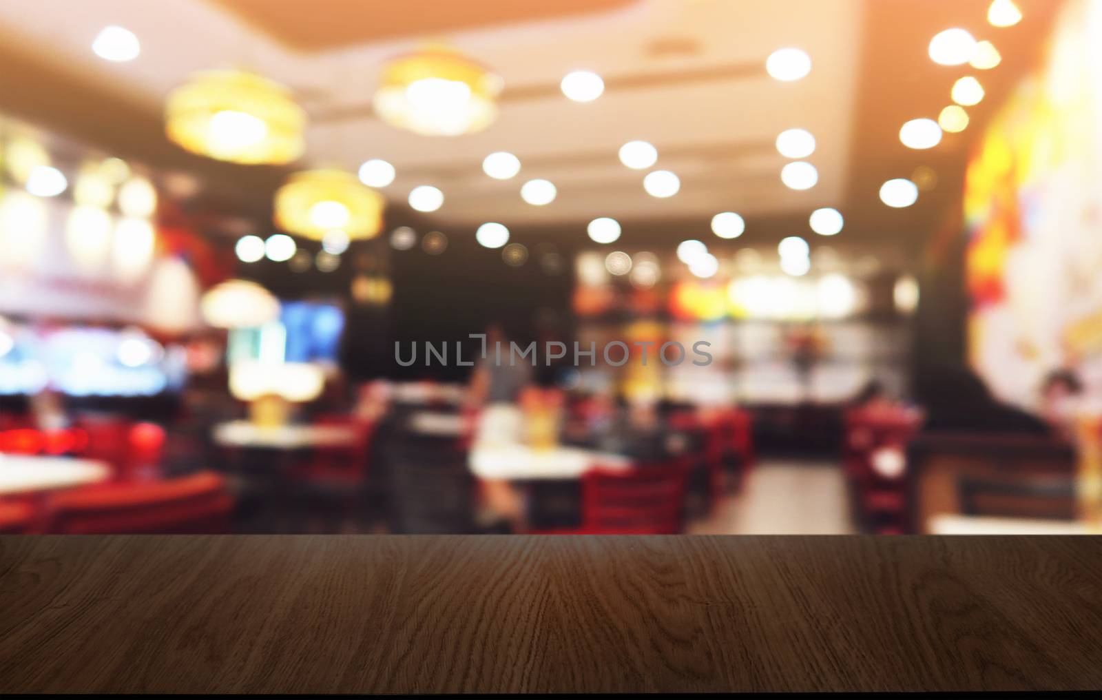 Empty dark wooden table in front of abstract blurred bokeh backg by peandben