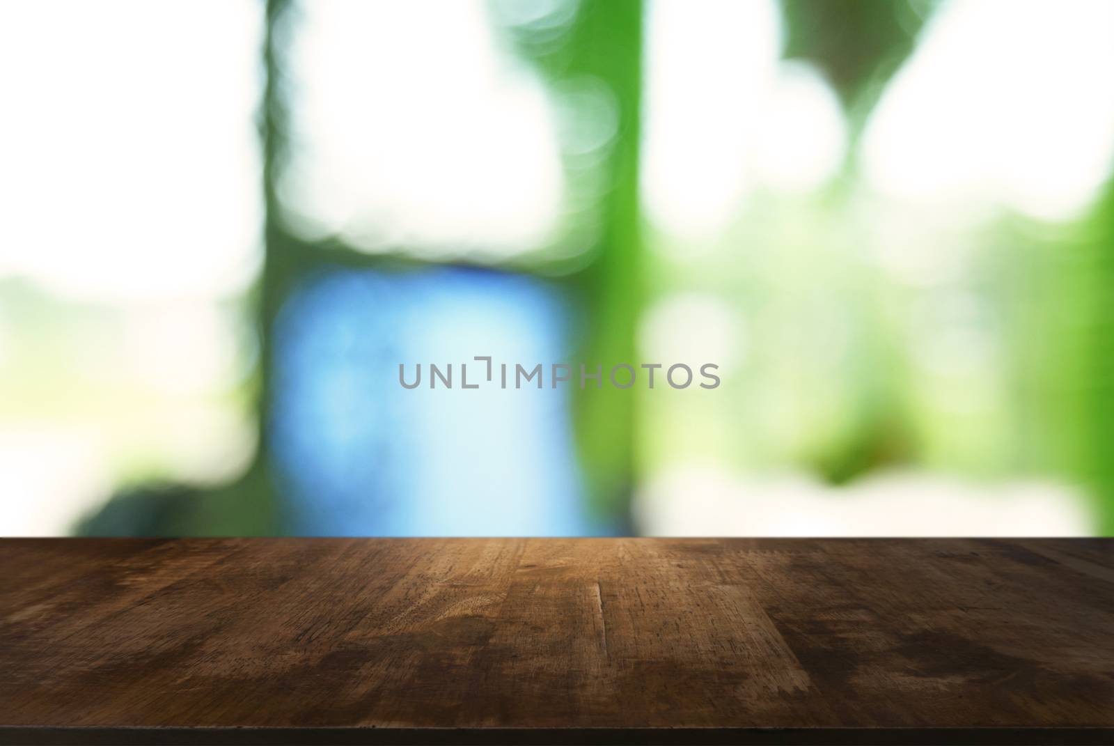 Empty dark wooden table in front of abstract blurred background  by peandben