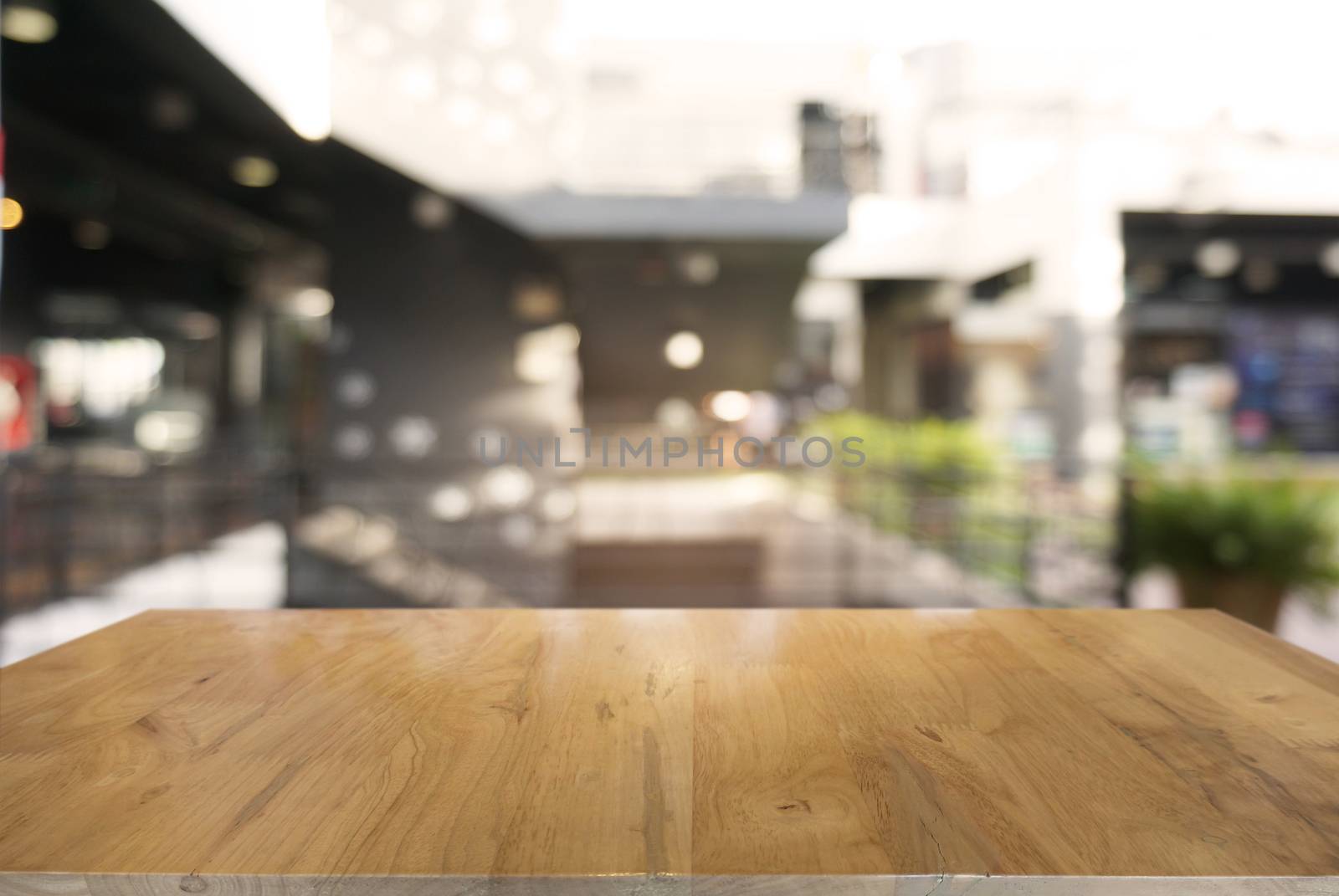 Empty dark wooden table in front of abstract blurred background  by peandben