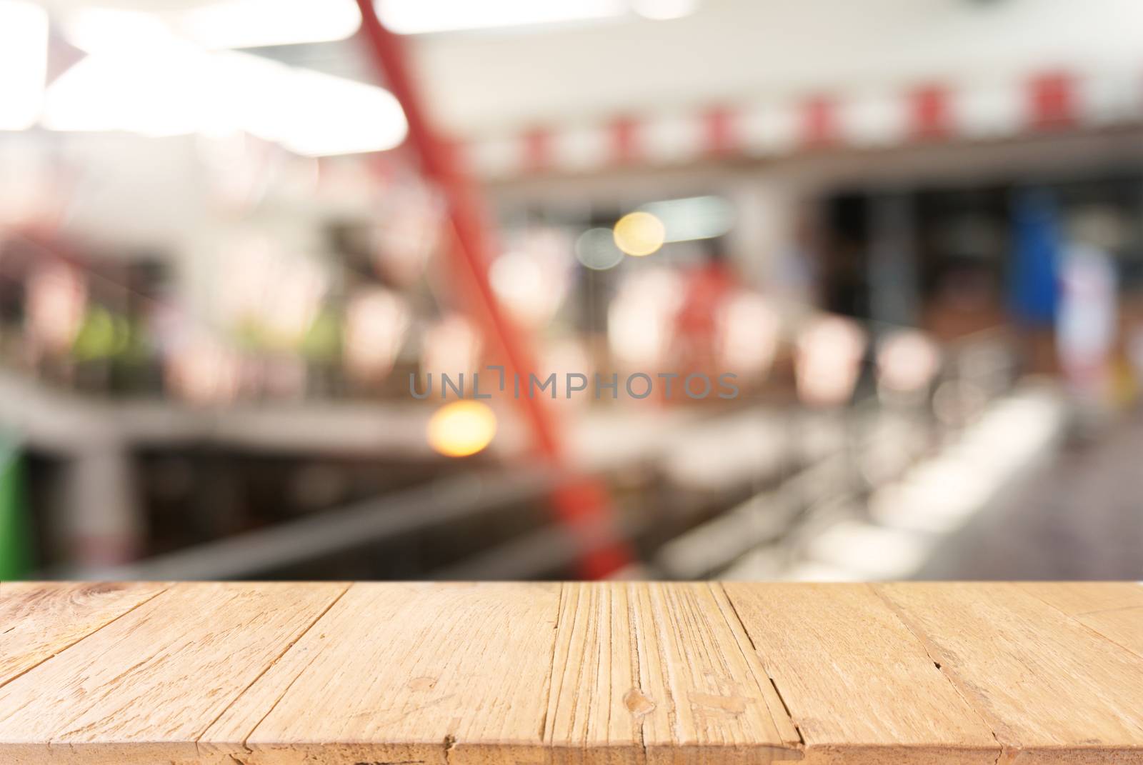 Empty dark wooden table in front of abstract blurred background of cafe and coffee shop interior. can be used for display or montage your products