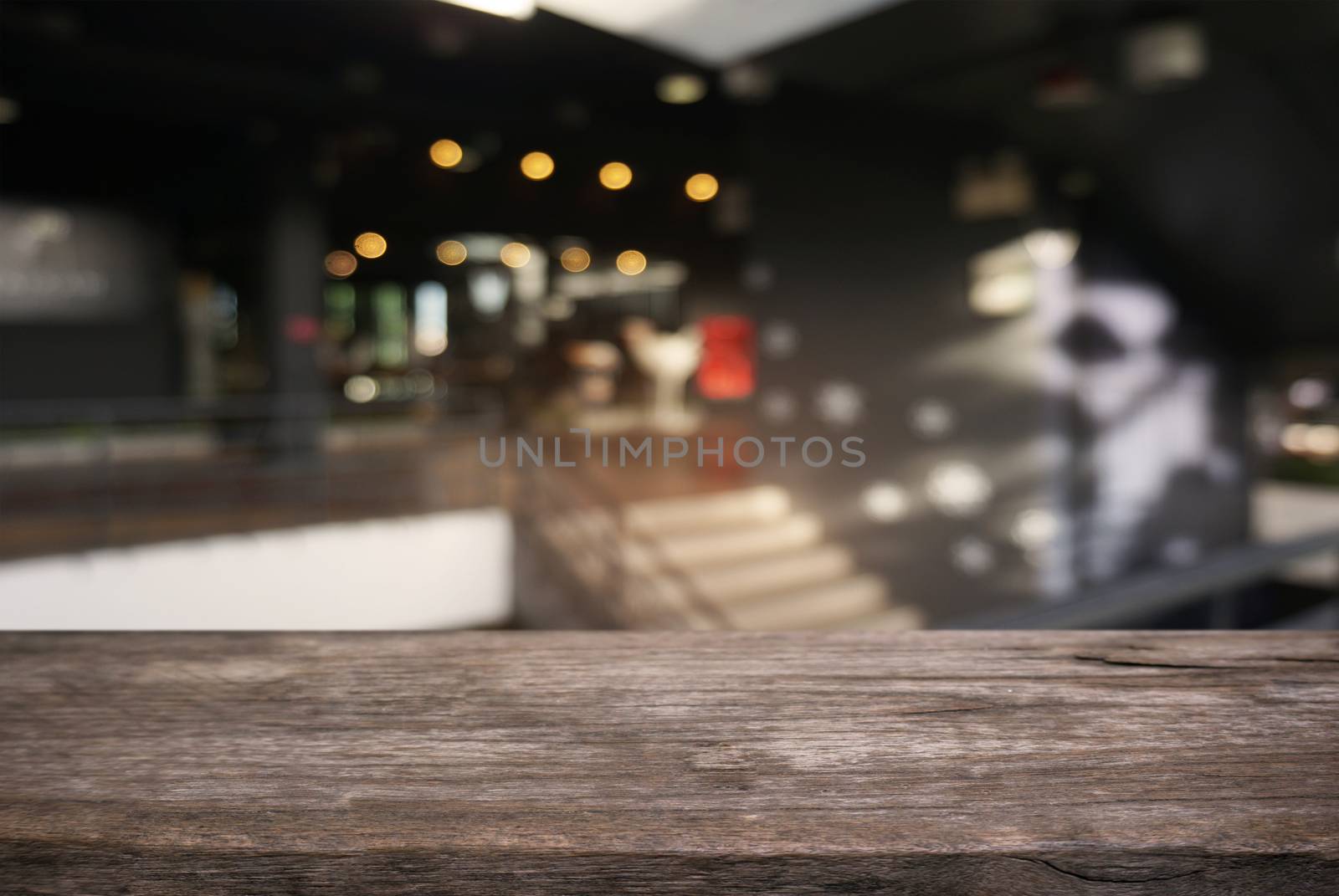 Empty dark wooden table in front of abstract blurred background  by peandben