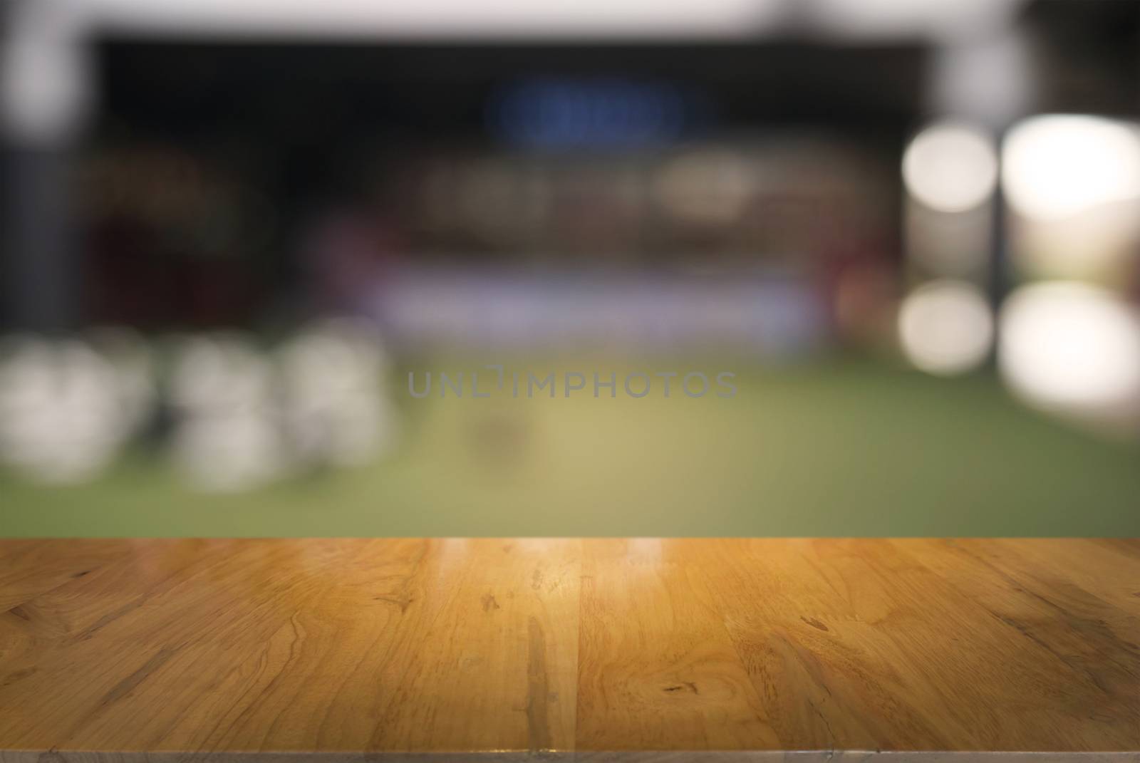 Empty dark wooden table in front of abstract blurred background  by peandben