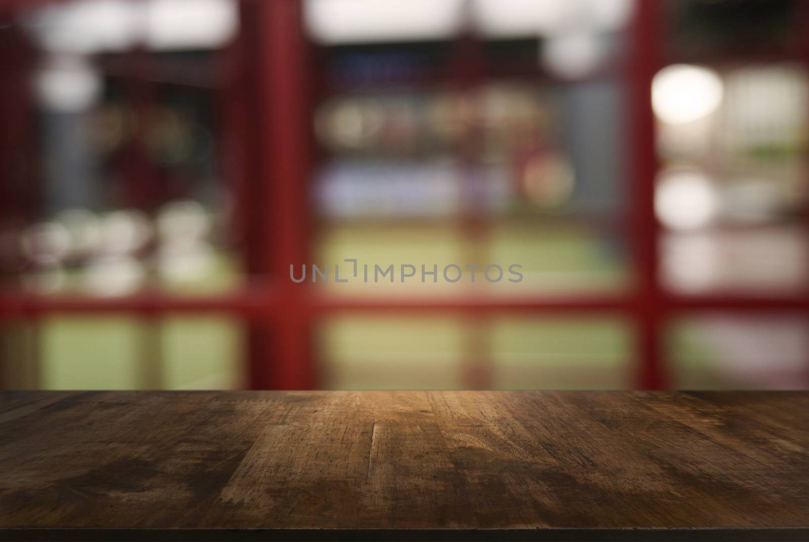 Empty dark wooden table in front of abstract blurred background  by peandben