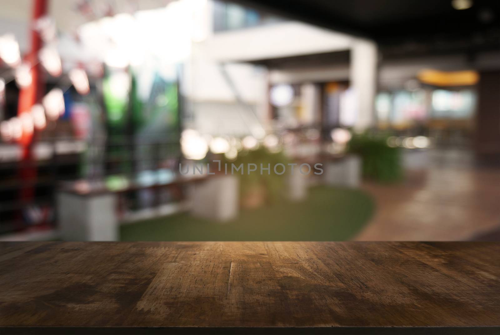 Empty dark wooden table in front of abstract blurred background  by peandben