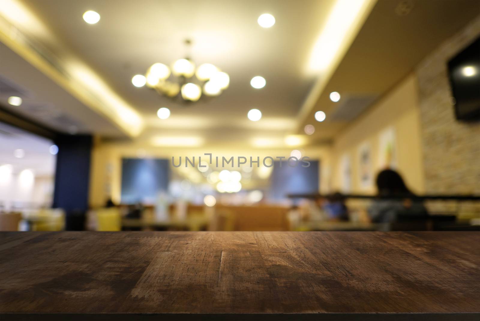 Empty dark wooden table in front of abstract blurred background  by peandben