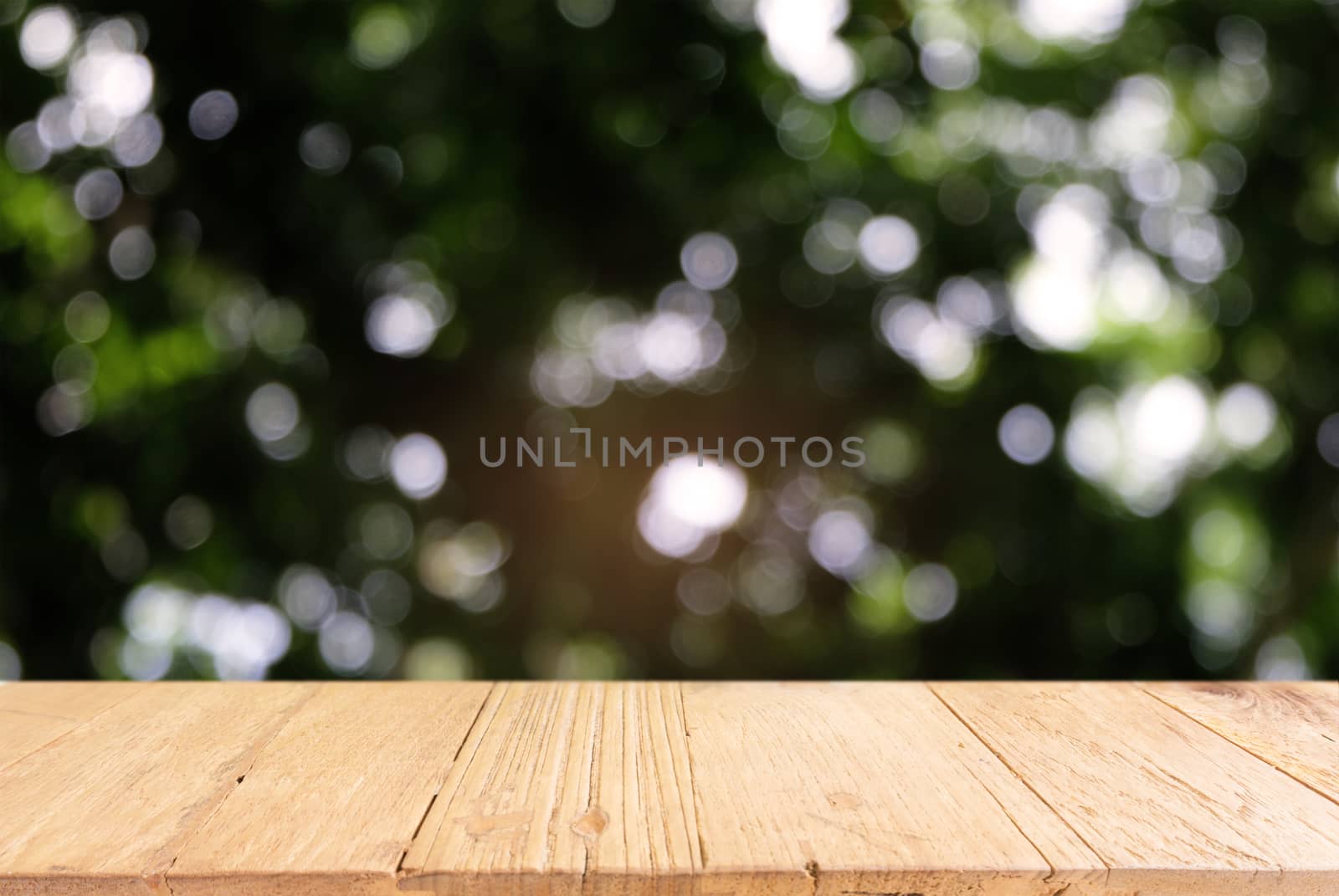 Image of dark wooden table in front of abstract blurred backgrou by peandben