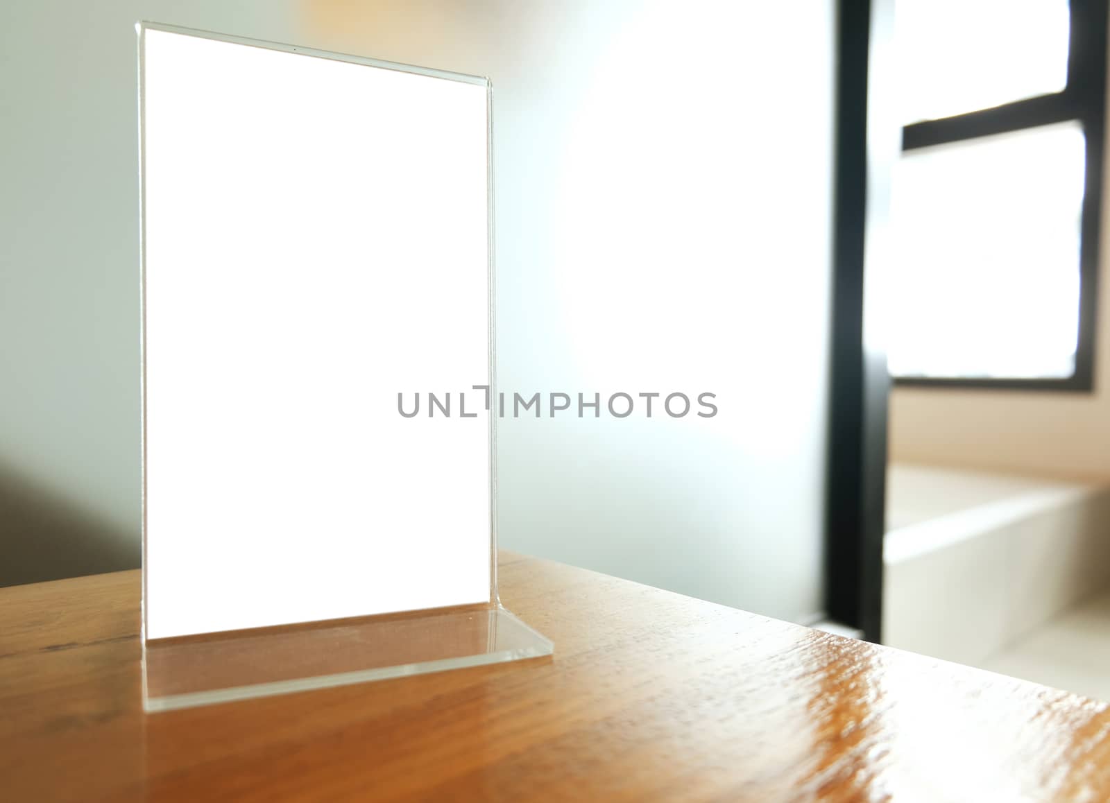 Mock up Menu frame standing on wood table in Bar restaurant cafe. space for text