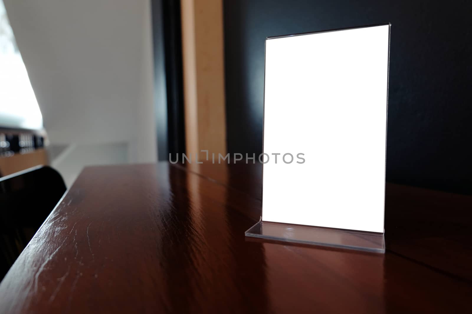 Mock up Menu frame standing on wood table in Bar restaurant cafe by peandben