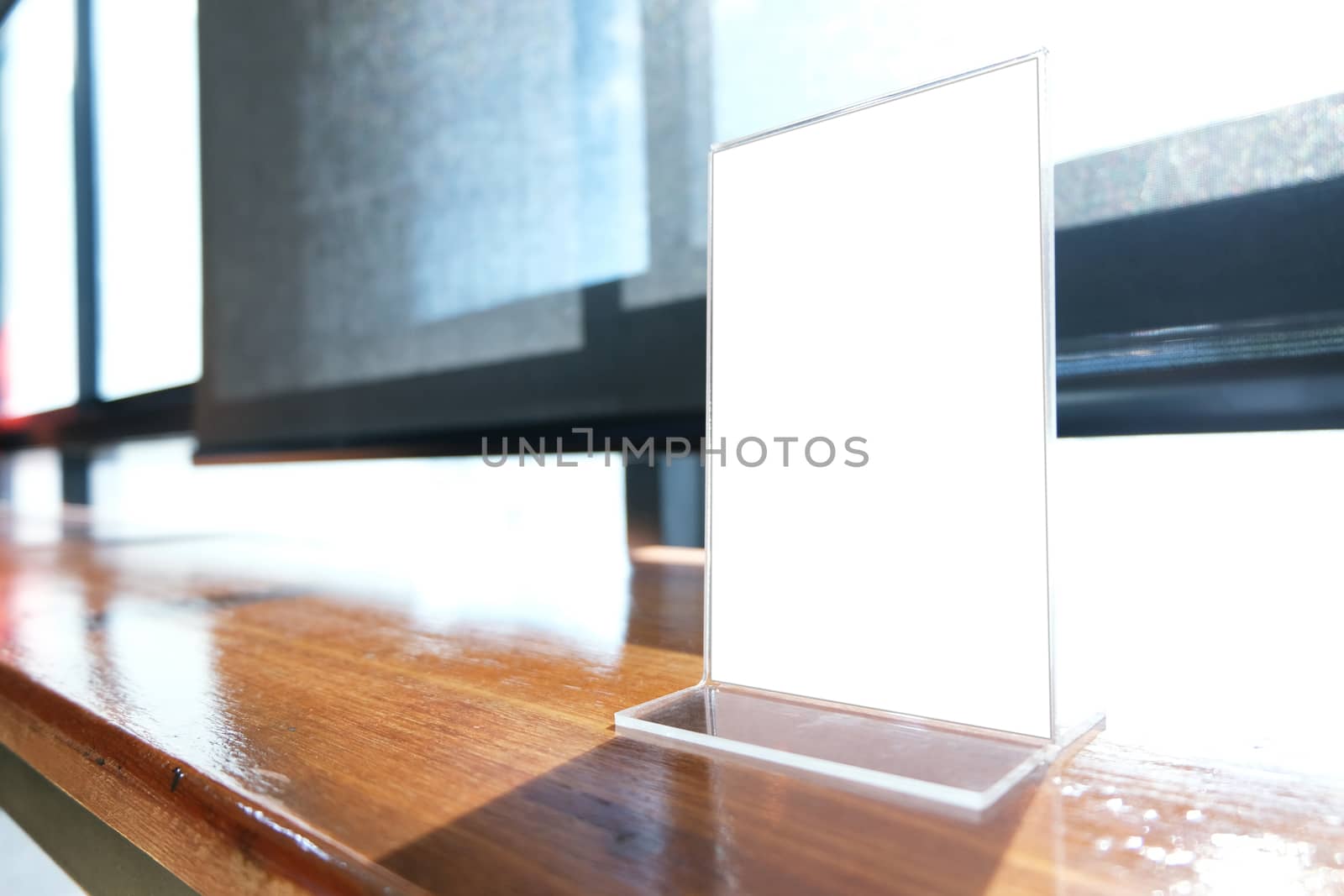 Mock up Menu frame standing on wood table in Bar restaurant cafe. space for text