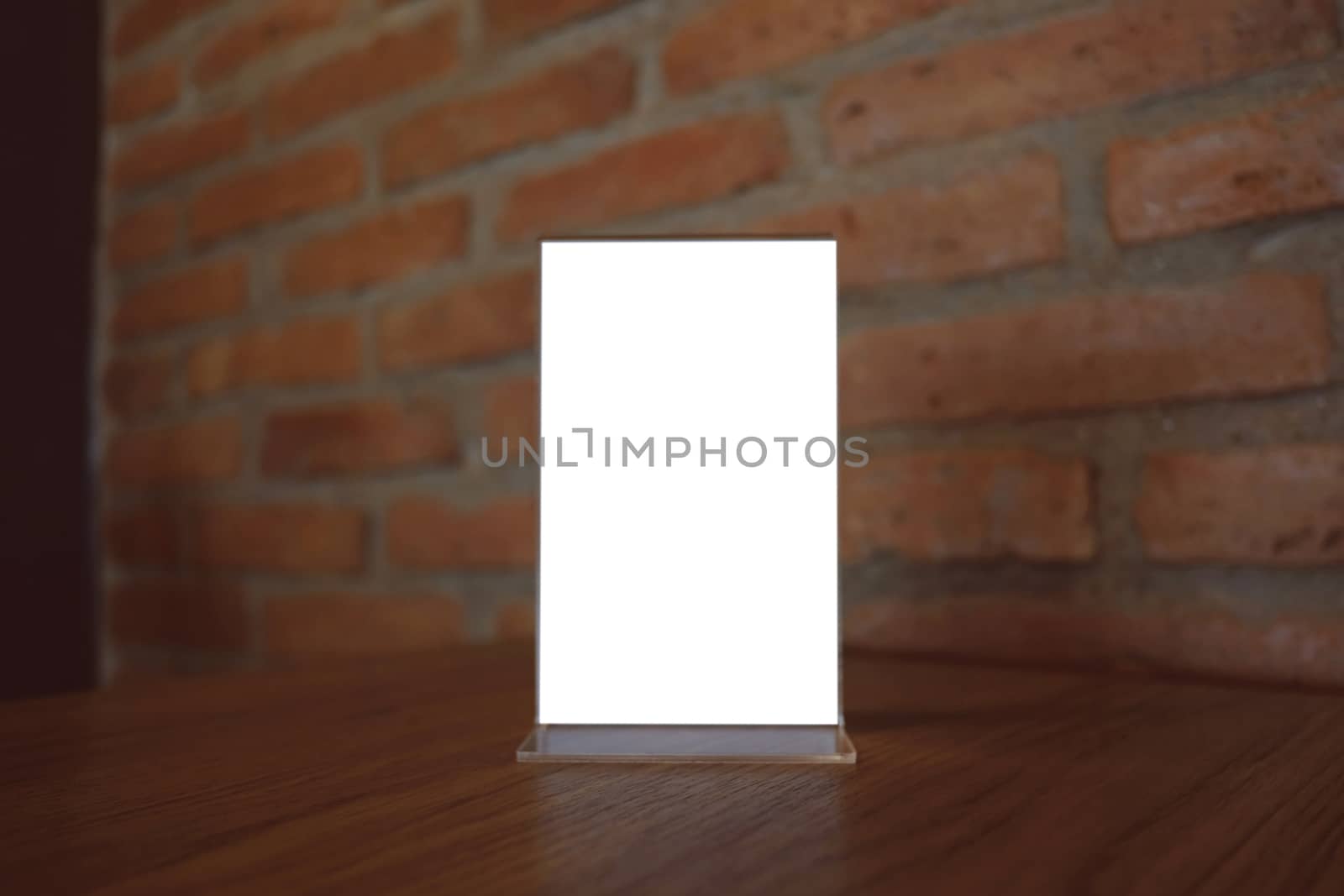 Mock up Menu frame standing on wood table in Bar restaurant cafe. space for text