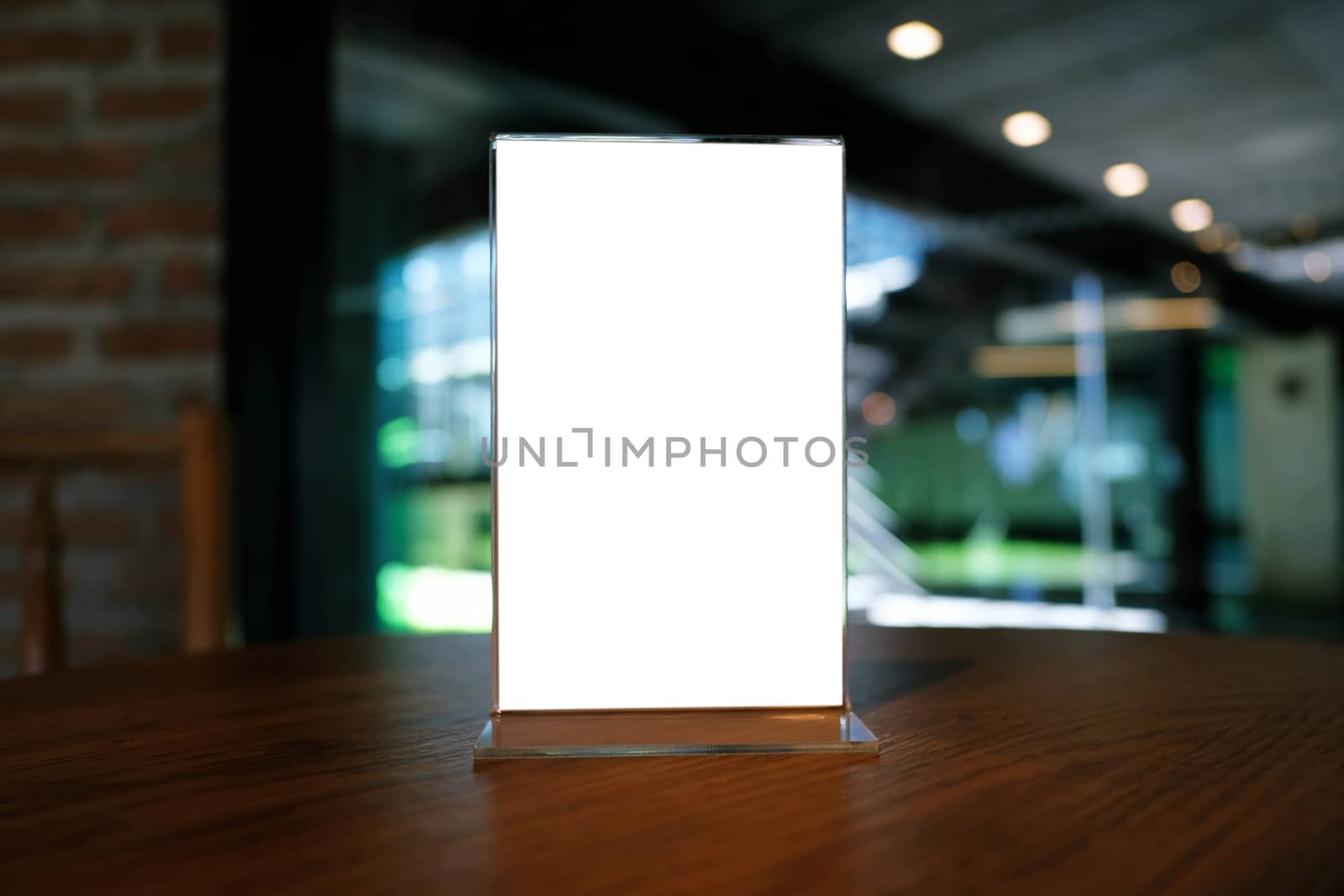 Mock up Menu frame standing on wood table in Bar restaurant cafe by peandben