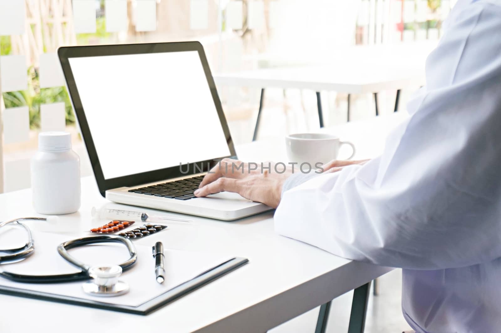 View of Details of doctor hands typing on keyboard with blank screen