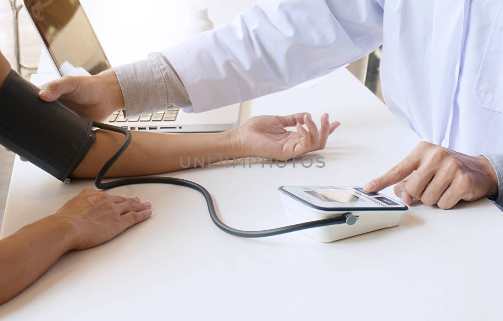 Doctor checking old woman patient arterial blood pressure. Health care.