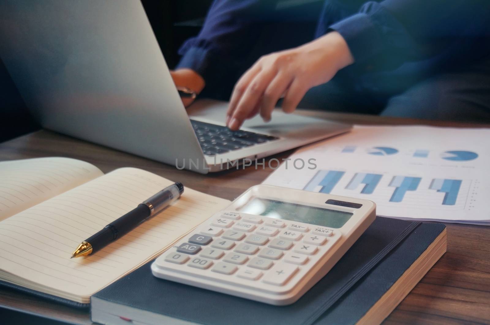 Business accounting women work with calculator and Laptop. Finan by peandben