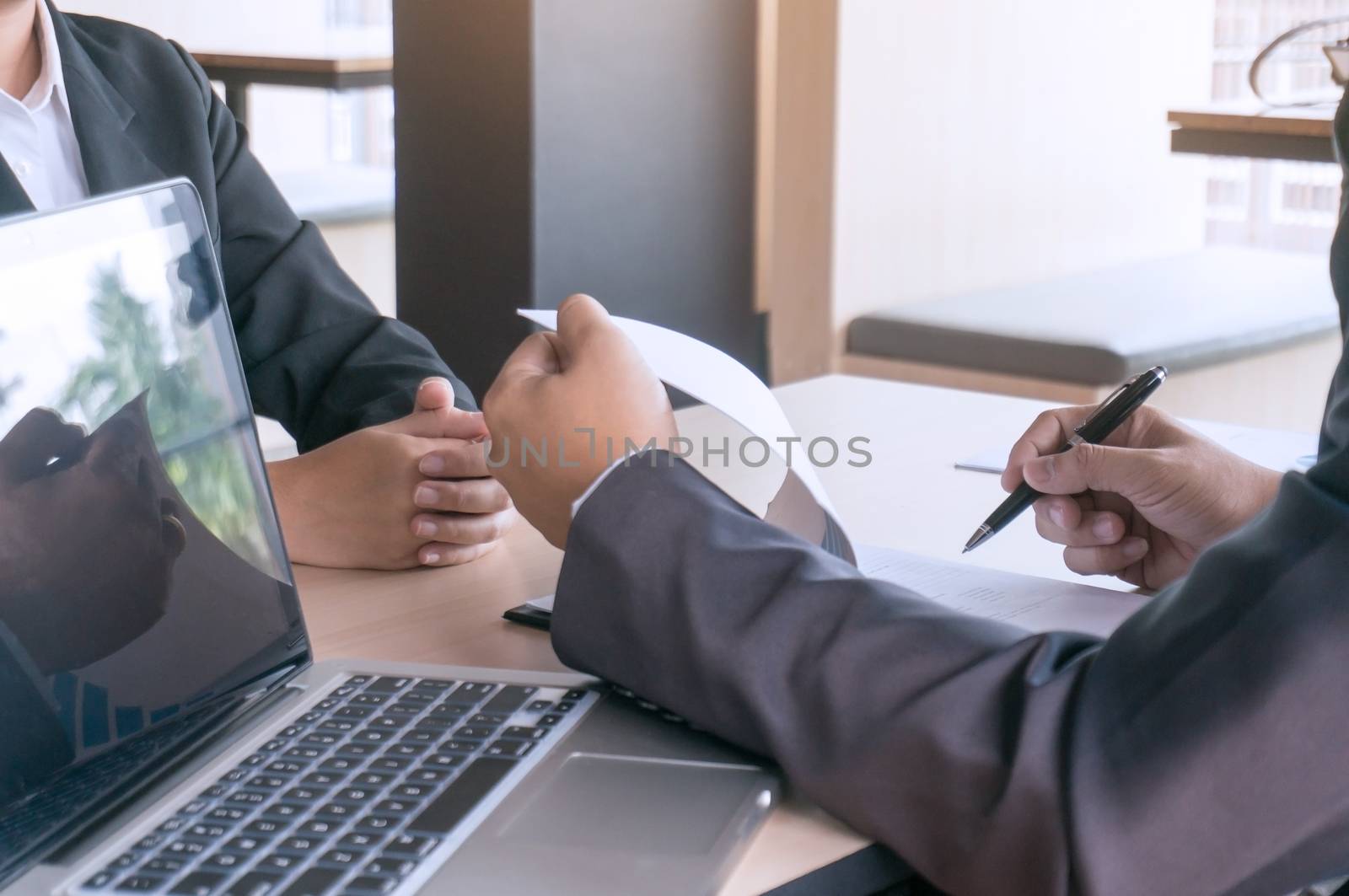 Examiner reading a resume during  job interview at office Busine by peandben