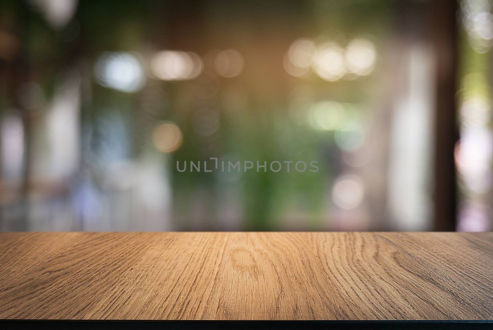 Empty wooden table in front of abstract blurred background of co by peandben