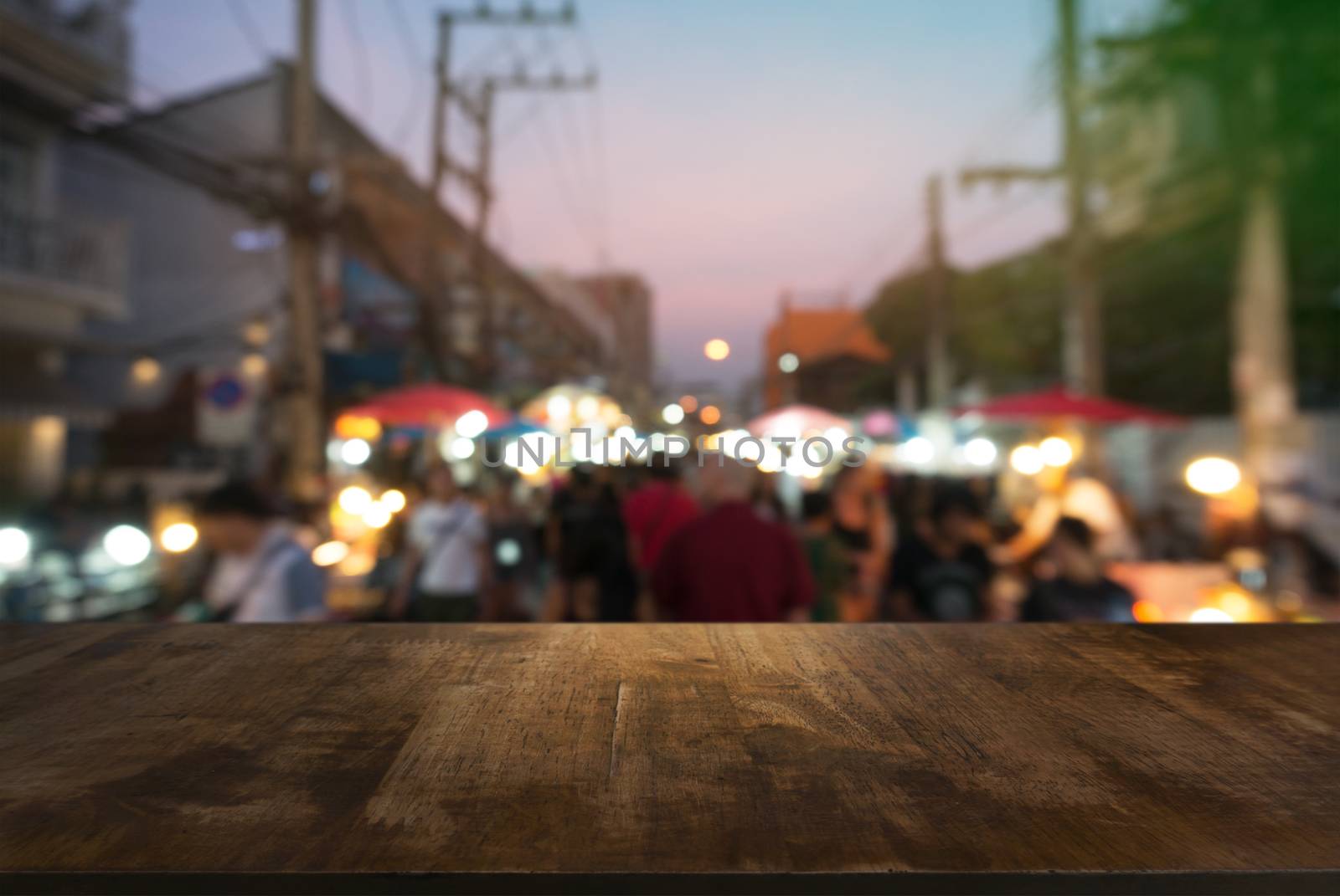 Empty wooden table in front of abstract blurred background of co by peandben