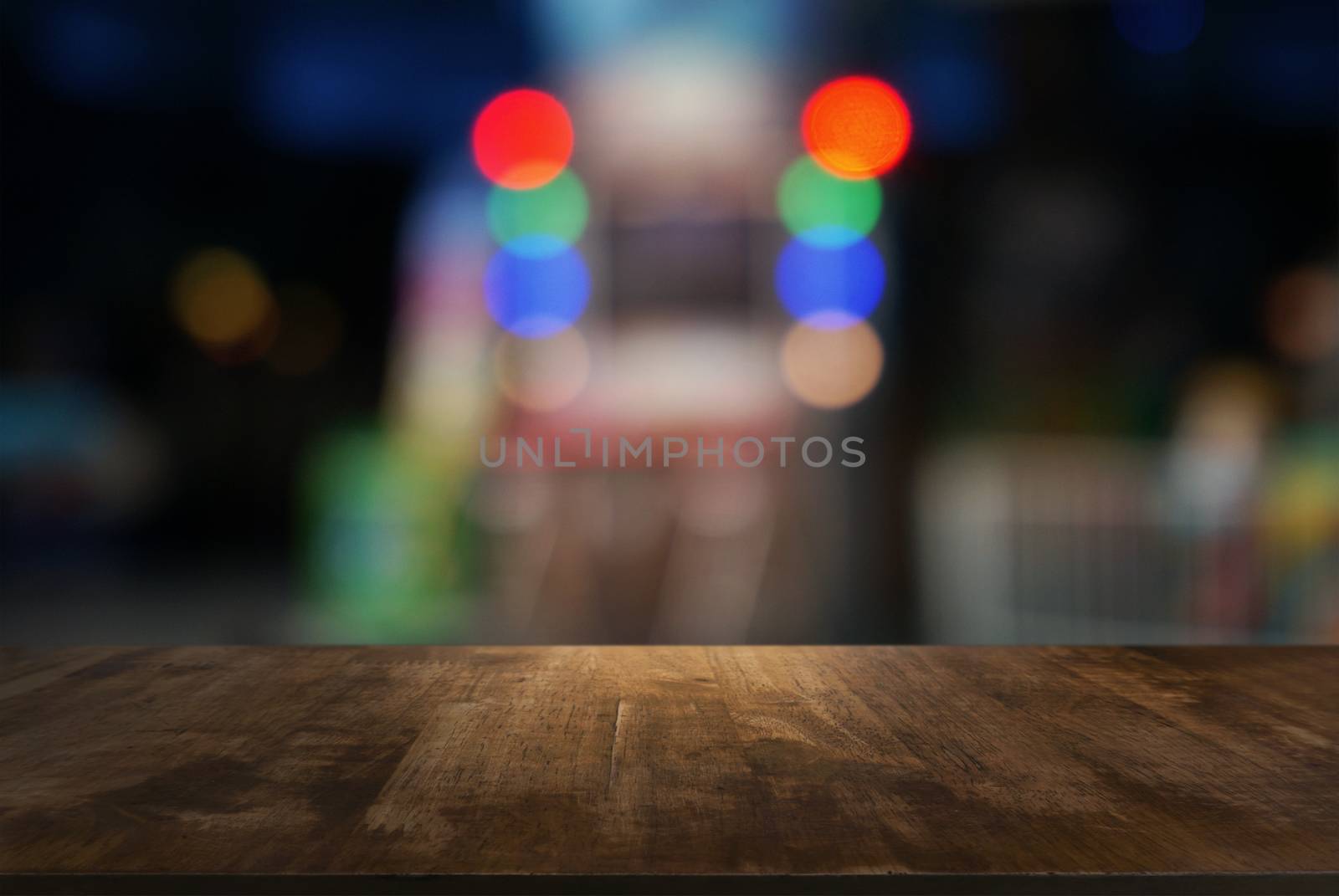 Empty wooden table in front of abstract blurred background of co by peandben