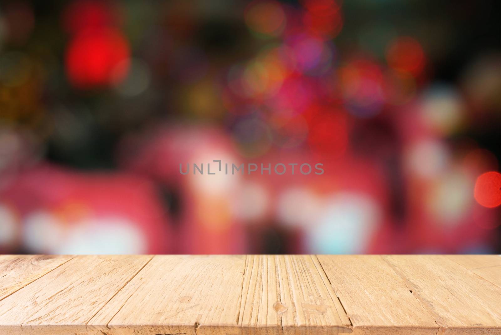 Empty wooden table in front of abstract blurred background of co by peandben