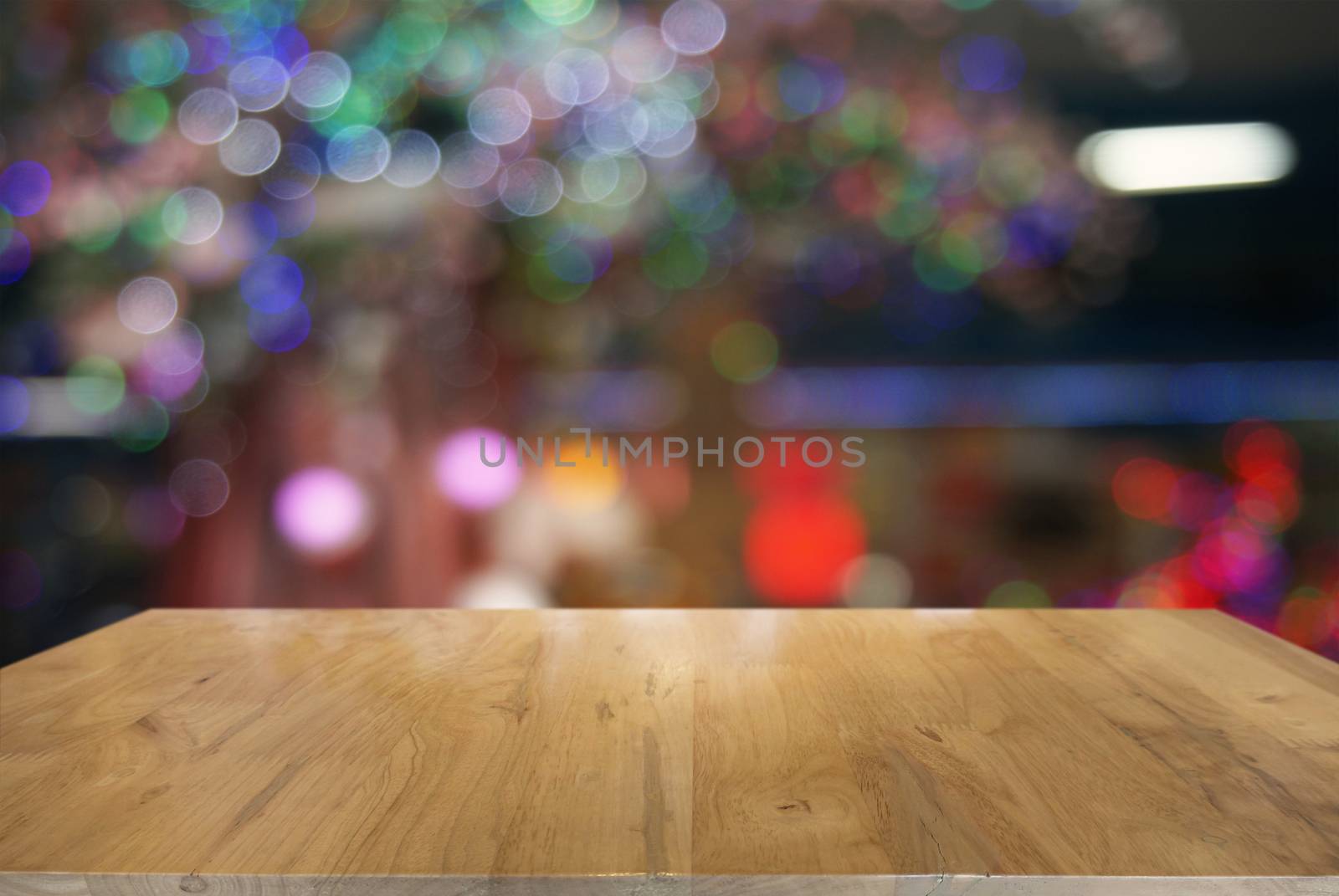 Empty wooden table in front of abstract blurred background of co by peandben