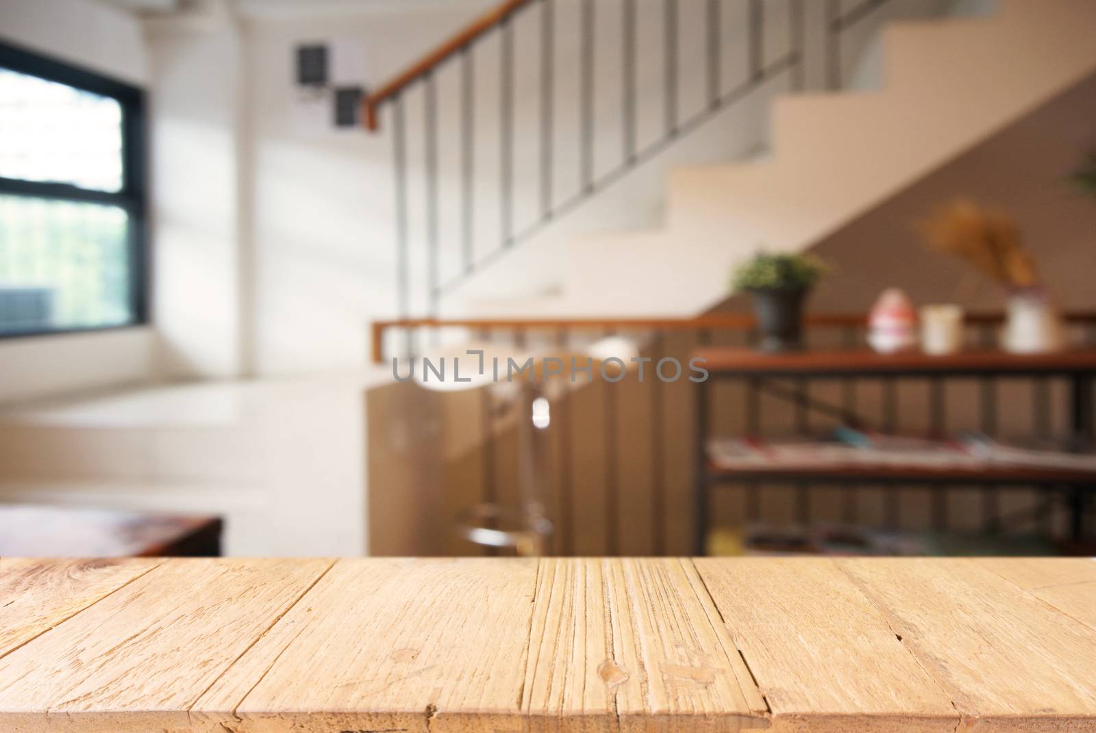 Empty wooden table in front of abstract blurred background of co by peandben