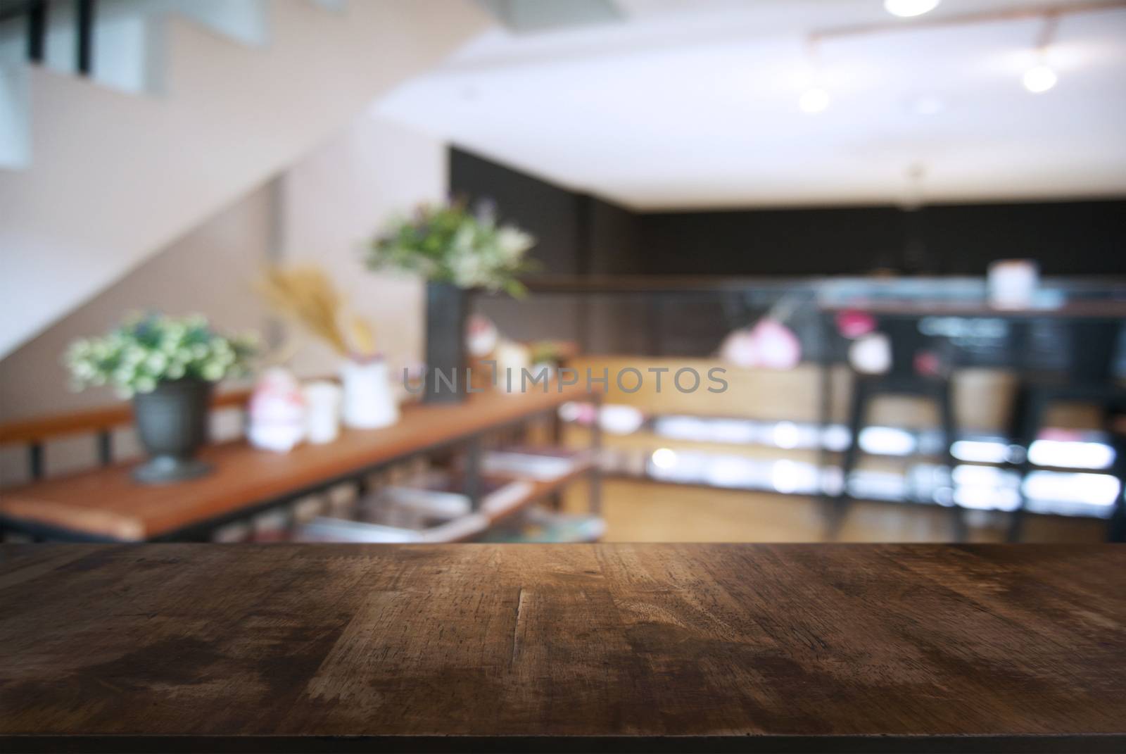 Empty wooden table in front of abstract blurred background of co by peandben