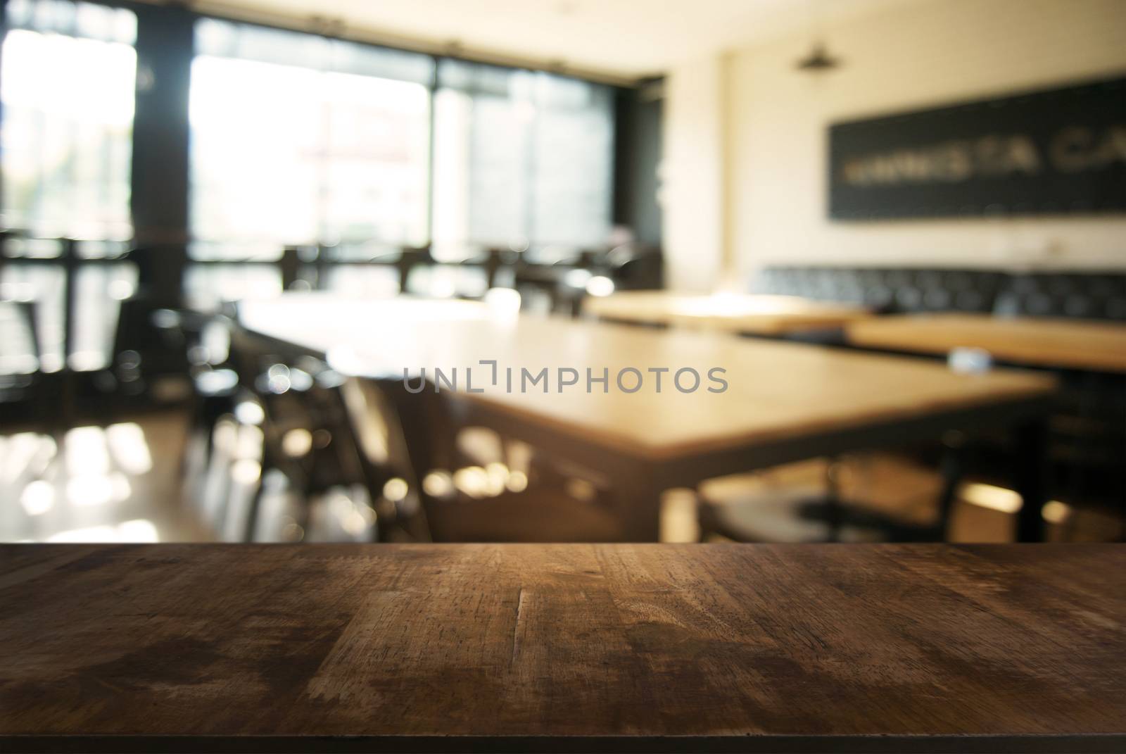 Empty wooden table in front of abstract blurred background of co by peandben