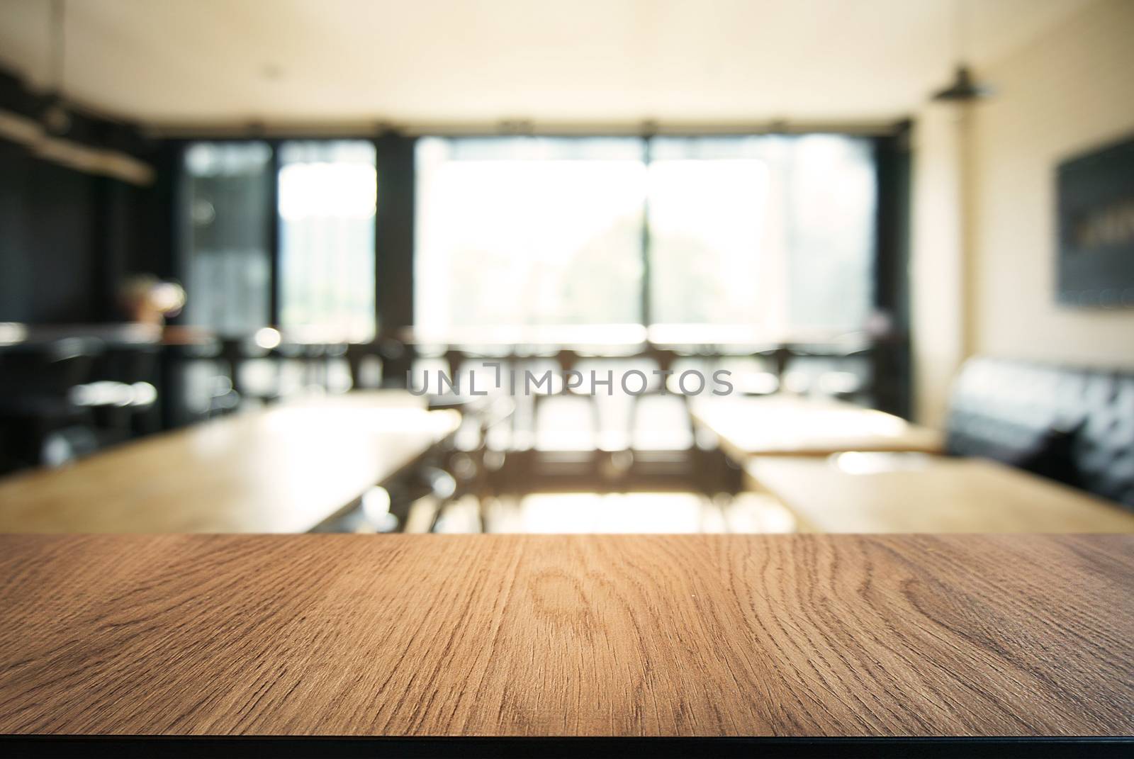 Empty wooden table in front of abstract blurred background of co by peandben