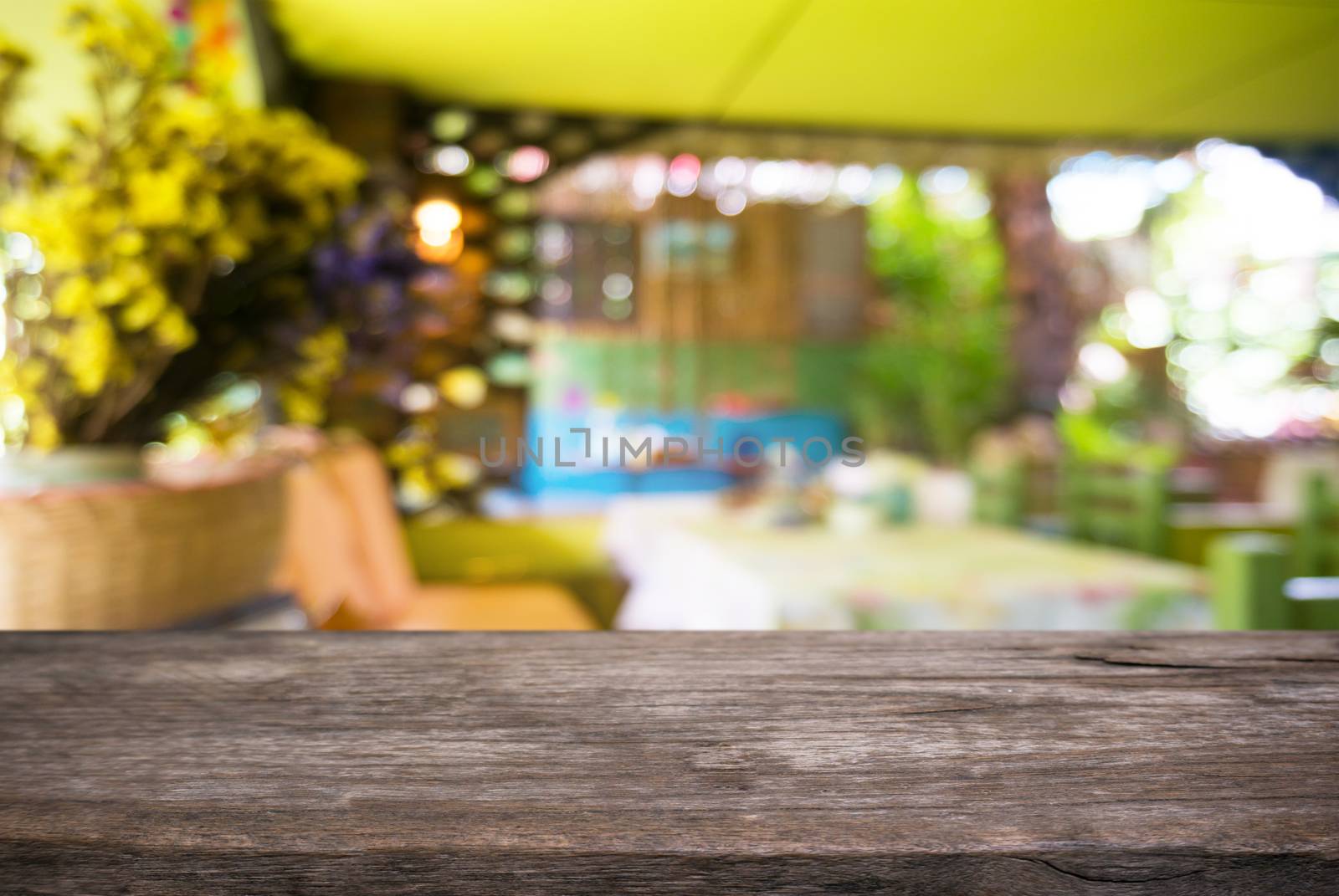 Empty wooden table in front of abstract blurred background of co by peandben