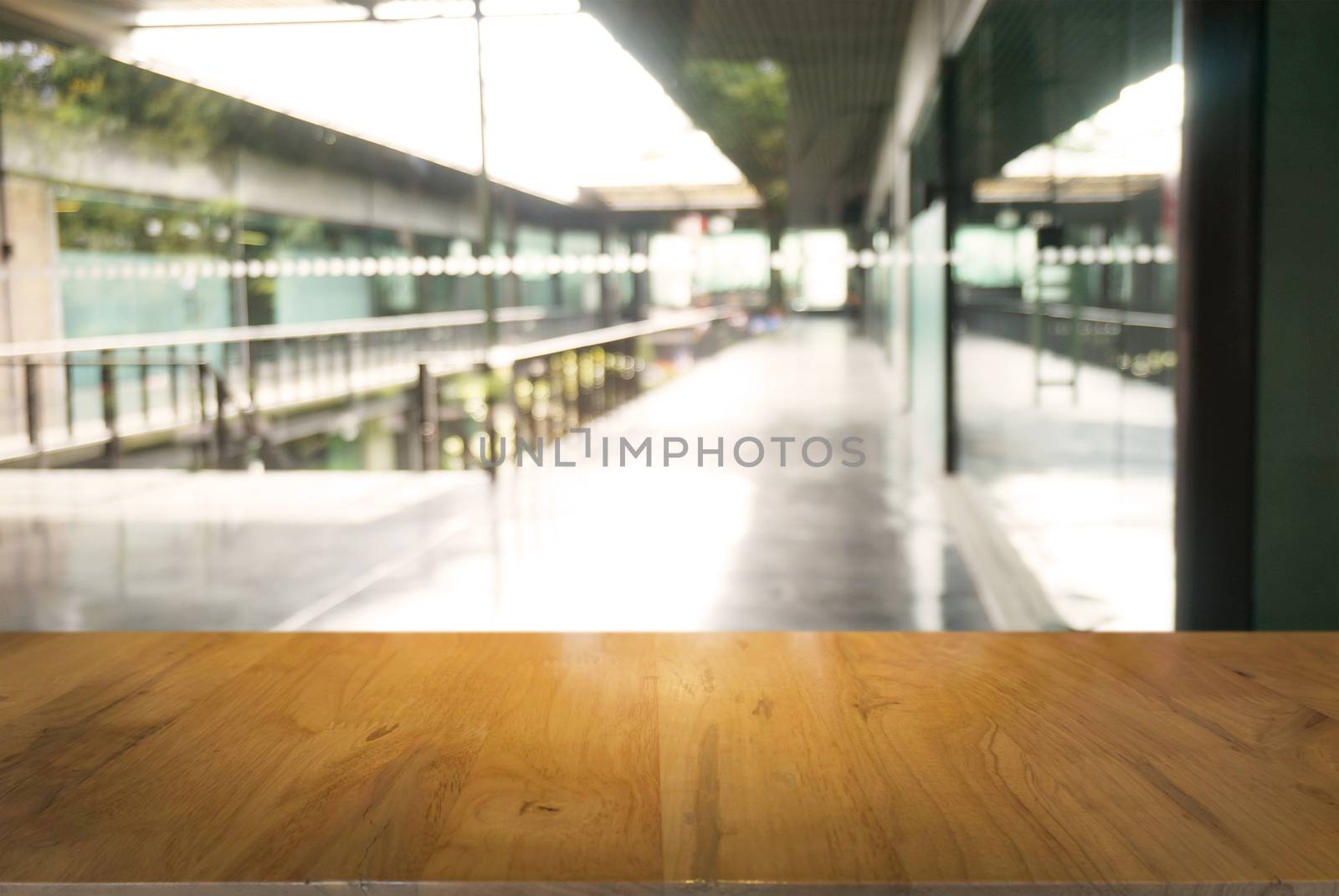 Empty wooden table in front of abstract blurred background of restaurant . can be used for display or montage your products.Mock up for display of counter