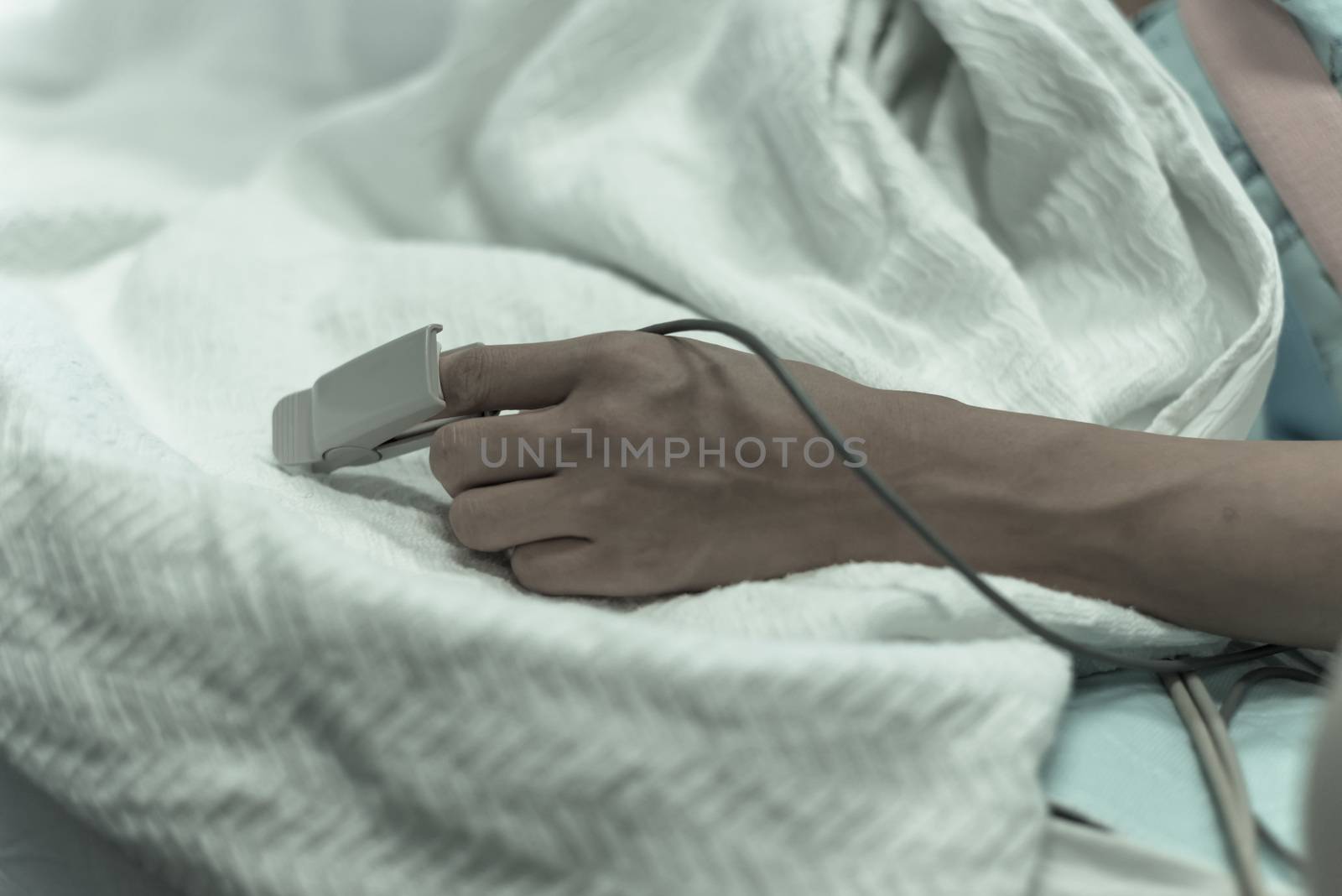 Vintage tone close-up pulse oximeter in a lady patient fingertip for heart rate and blood oxygen level monitoring at labor and delivery room