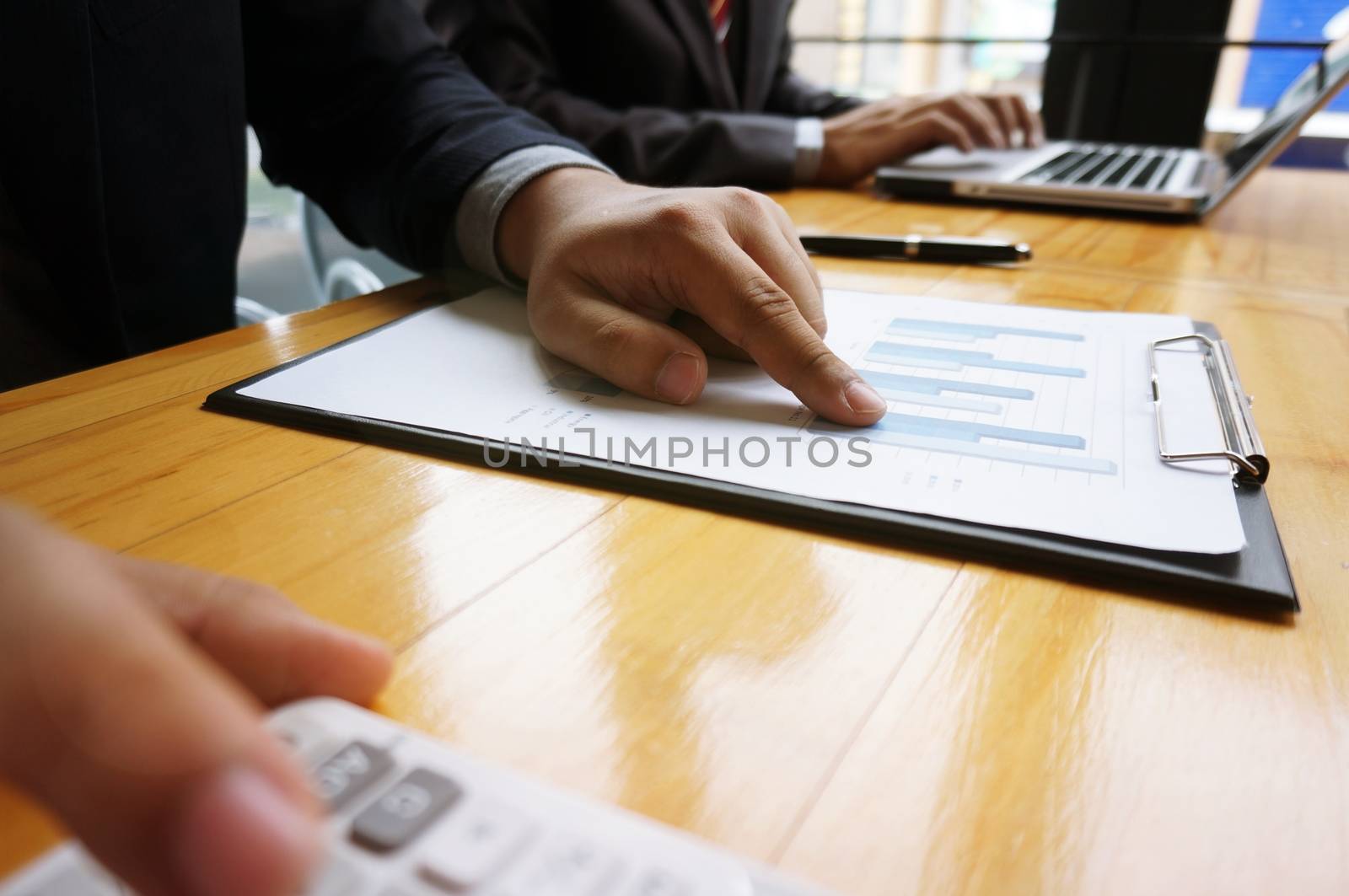 Hands of business people analyzing chart Finance managers task