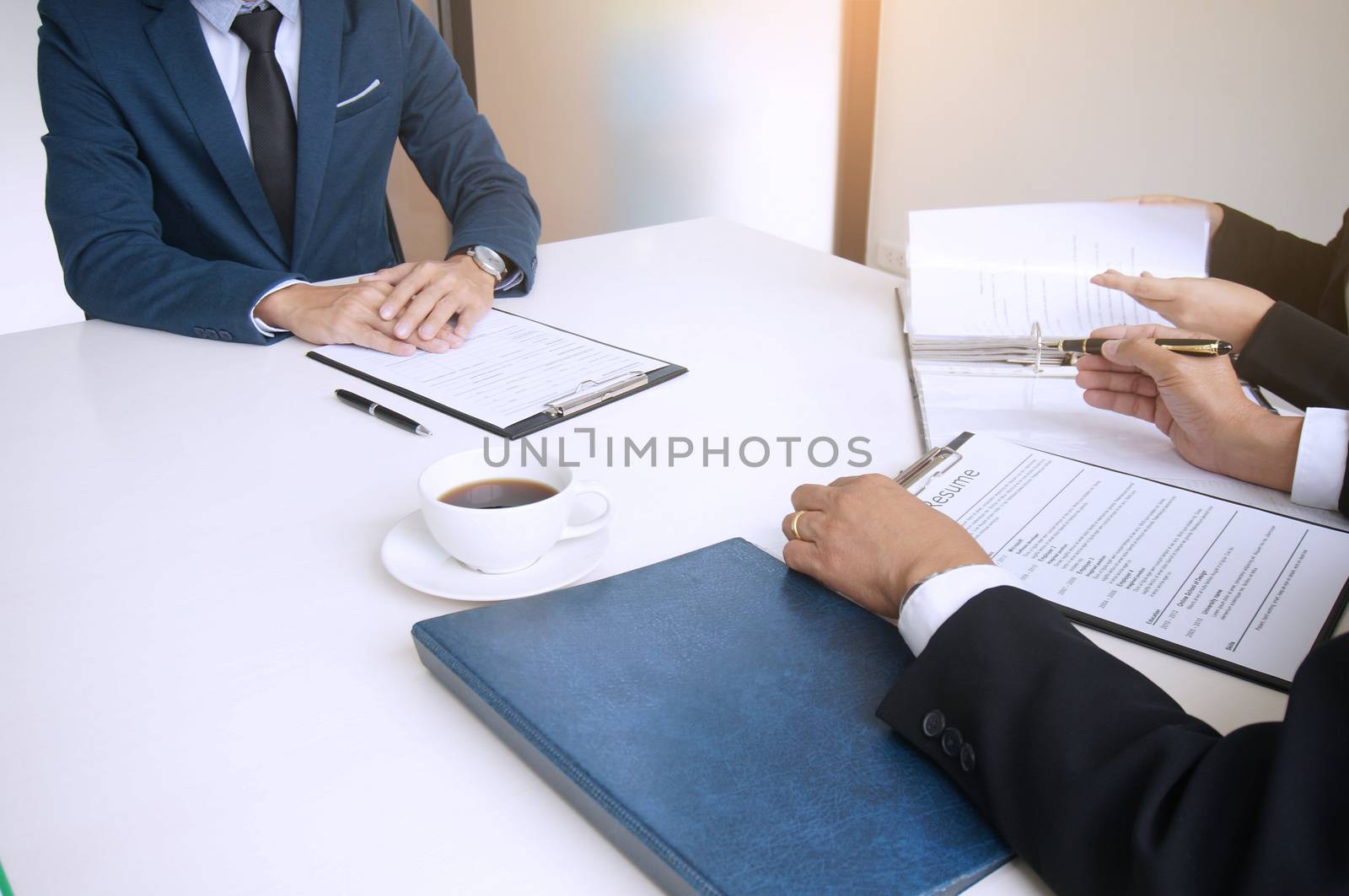 Examiner reading a resume during  job interview at office Business and human resources concept.