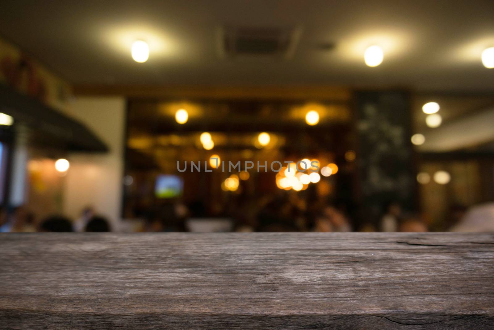 Empty wooden table in front of abstract blurred background of coffee shop . can be used for display Mock up  of product.