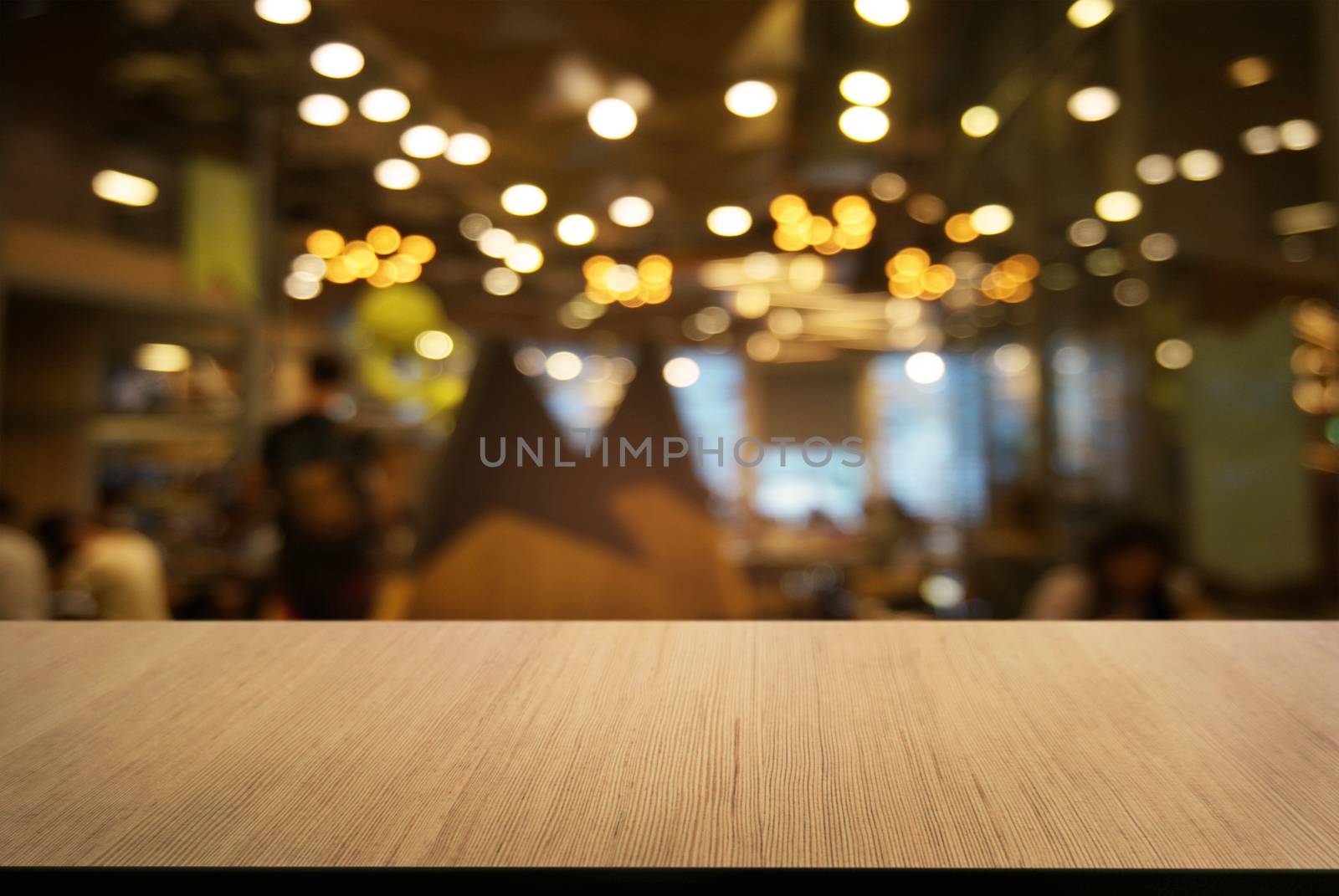 Empty wooden table in front of abstract blurred background of co by peandben