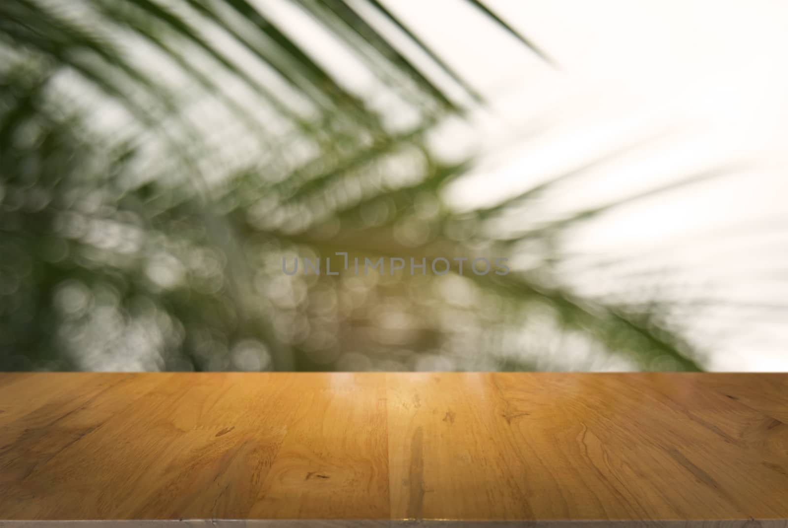 image of wooden table in front of abstract blurred background of outdoor garden lights. can be used for display or montage your products.Mock up for display of product