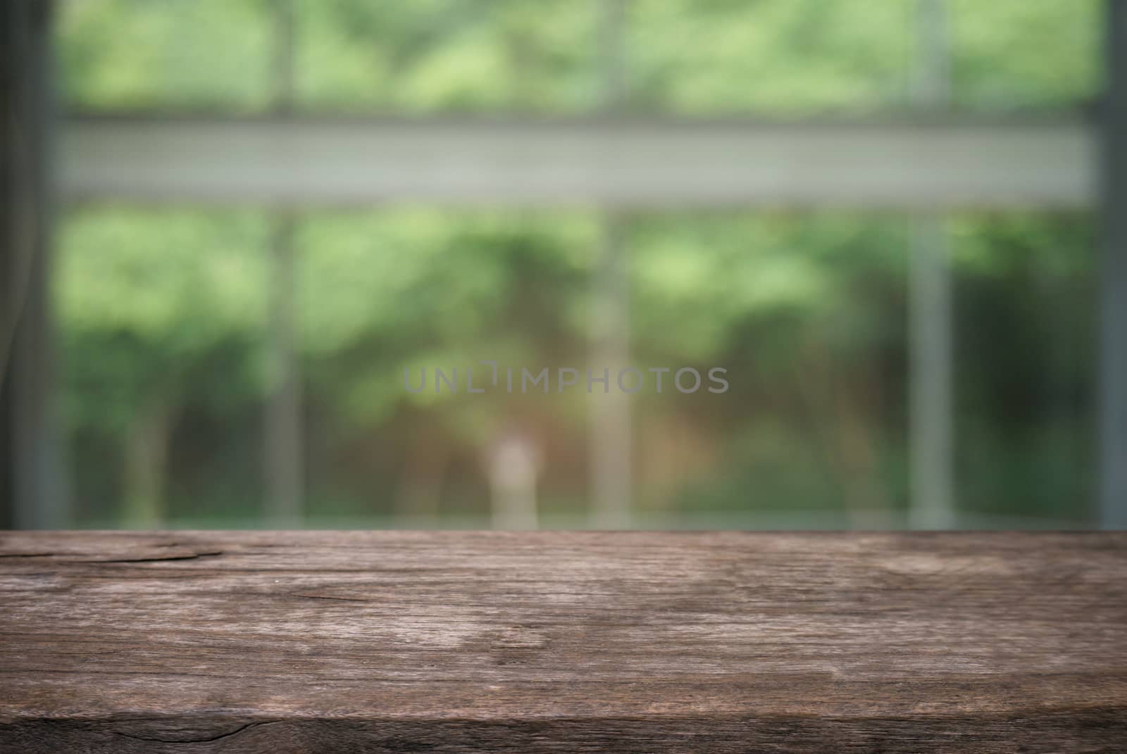 image of wooden table in front of abstract blurred background of outdoor garden lights. can be used for display or montage your products.Mock up for display of product