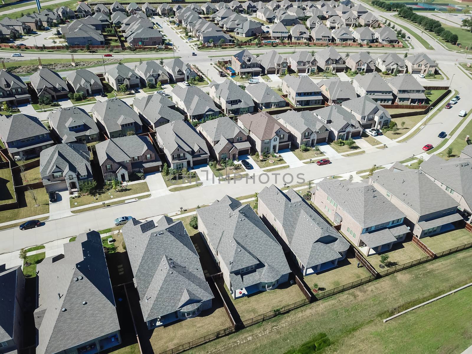 Aerial view new development community with row of detached single-family house and garden. Flyover residential area suburban Dallas, Texas, USA