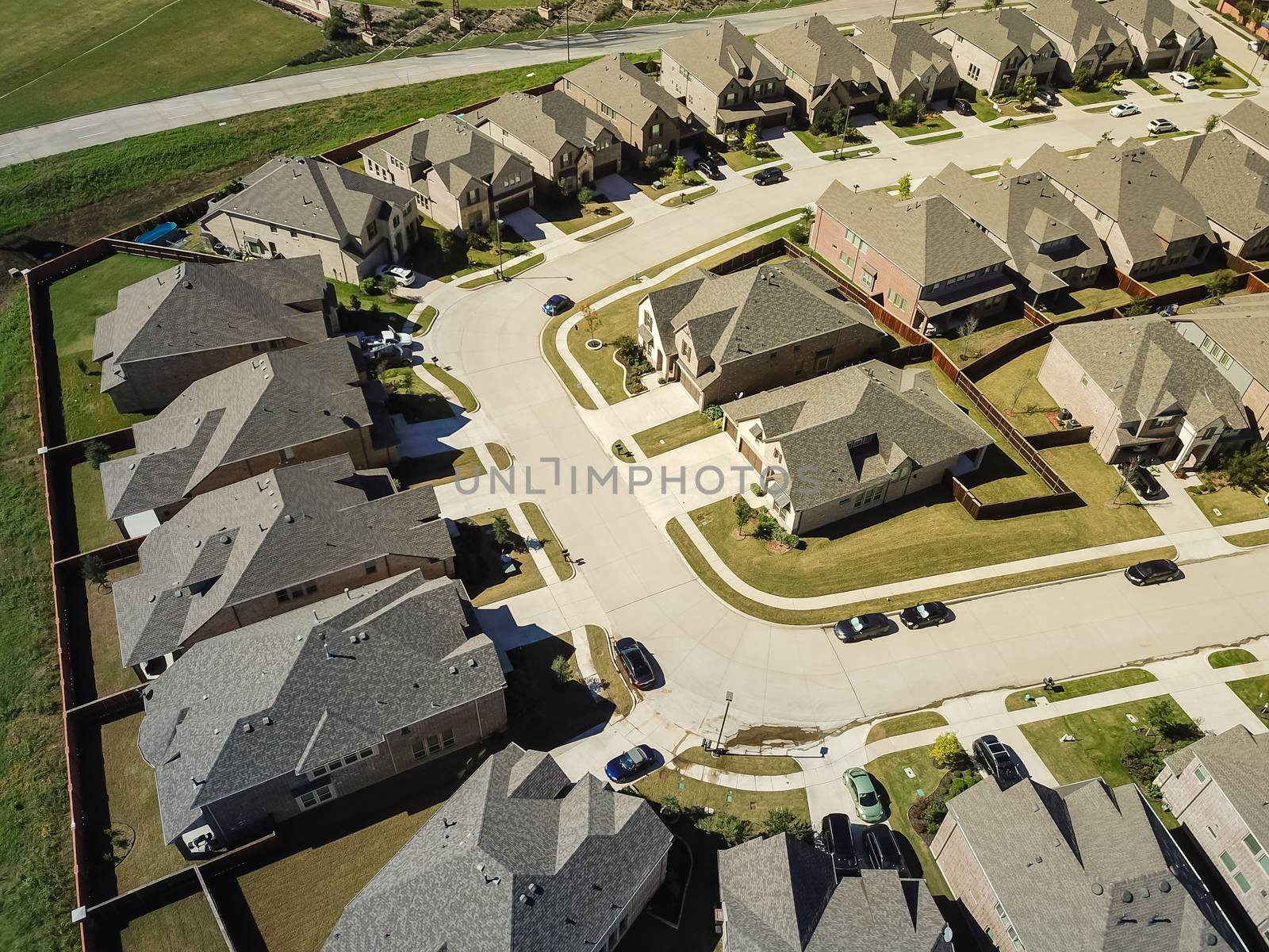 Aerial view new development community with row of detached single-family house and garden. Flyover residential area suburban Dallas, Texas, USA