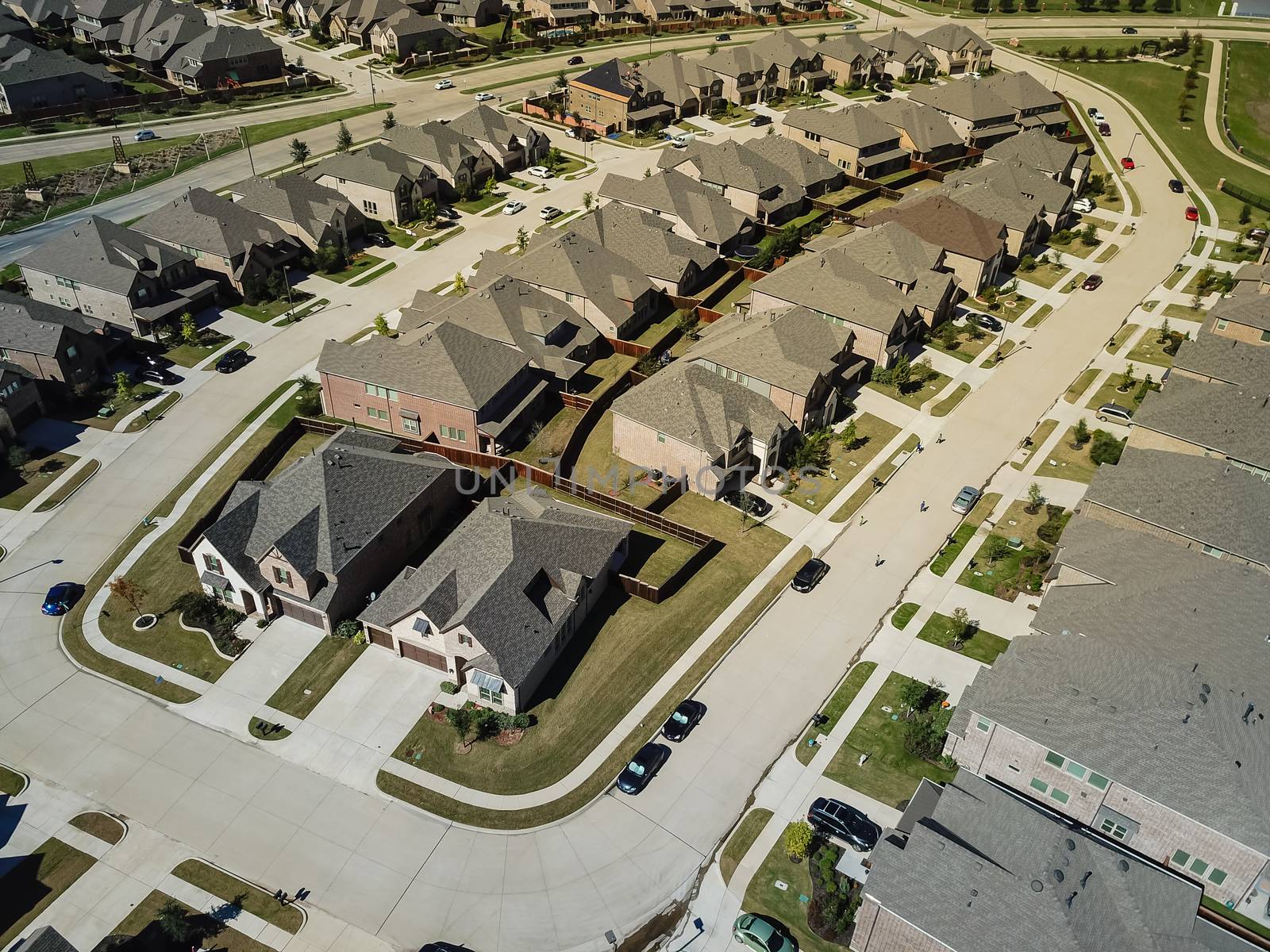 Aerial view new development community with row of detached single-family house and garden. Flyover residential area suburban Dallas, Texas, USA