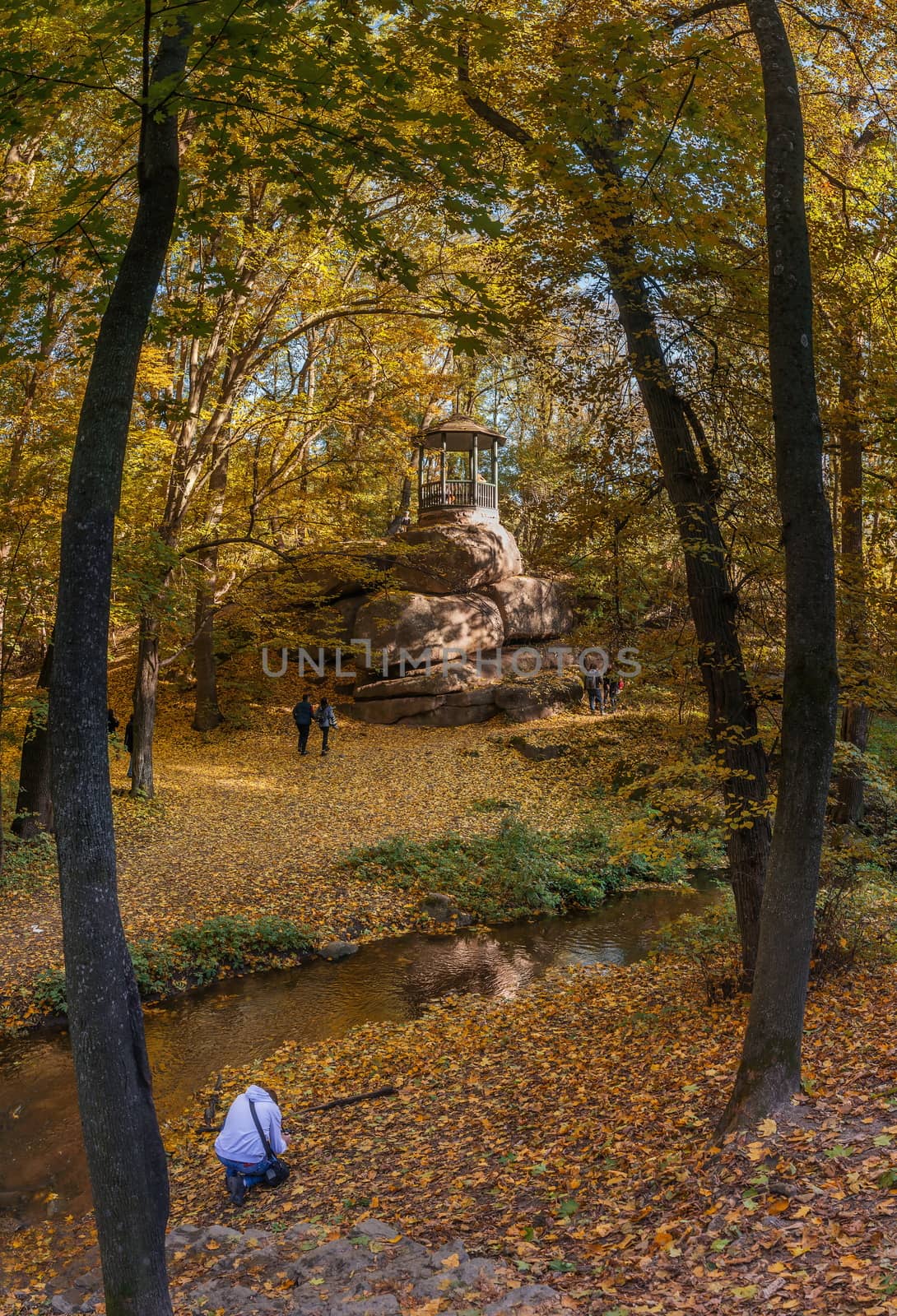 Uman, Ukraine - 10.13.2018. Beautiful autumn trees around the old alcove in Sofiyivka park, Ukraine