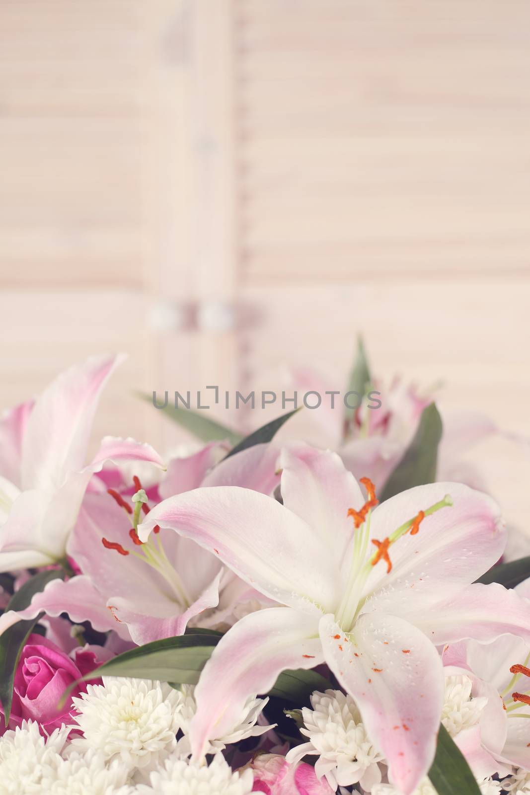 Bouquet of flowers on light wooden background