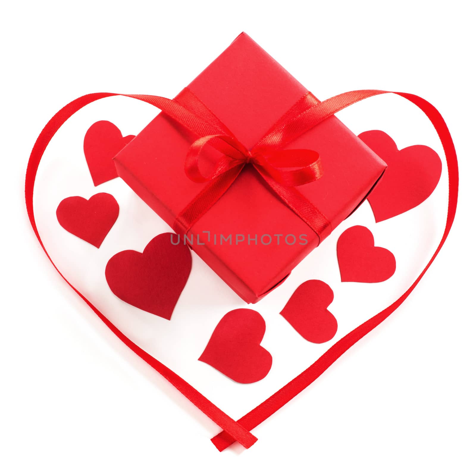 Small red gift box with ribbon bow and paper hearts studio isolated on white background