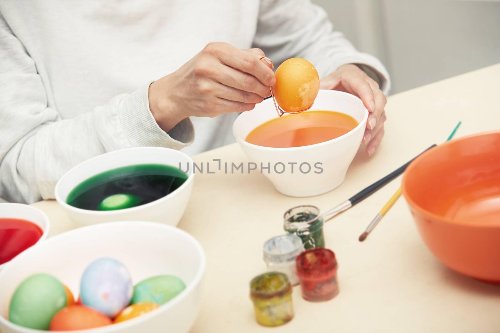 Woman preparing and dying Easter eggs