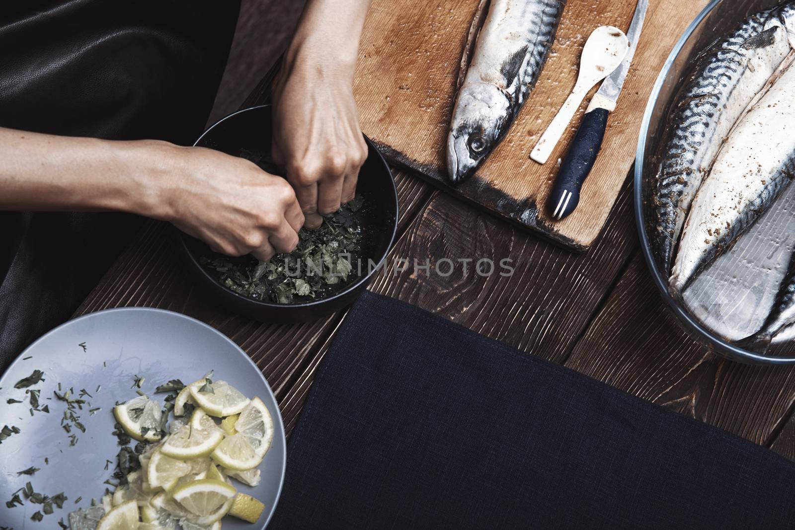 Woman preparing marinade for fish by Novic