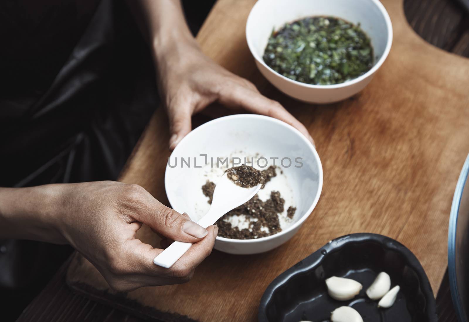 Woman preparing Indian sauce for vegetarian food by Novic