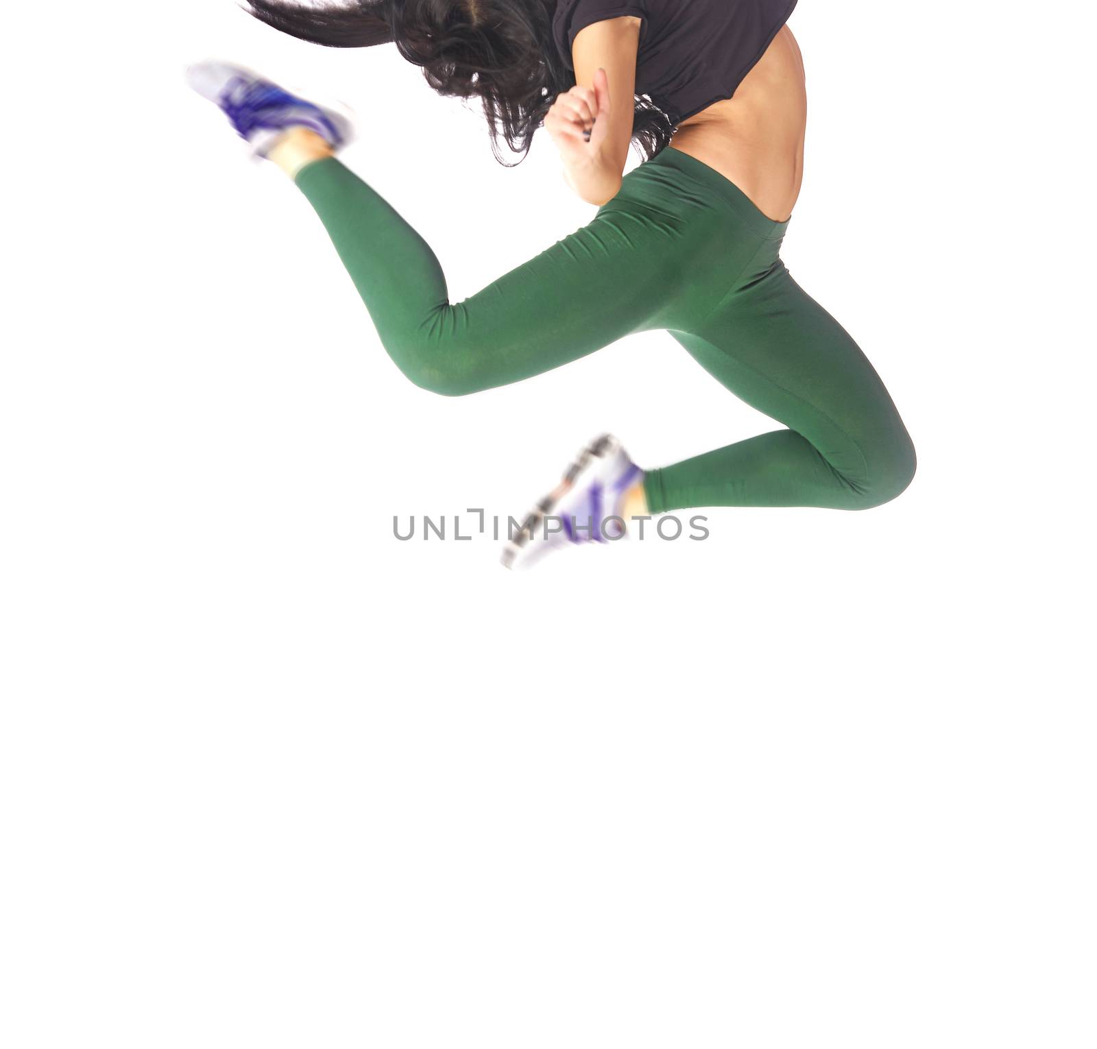 Woman jumping and dancing on a white background in studio