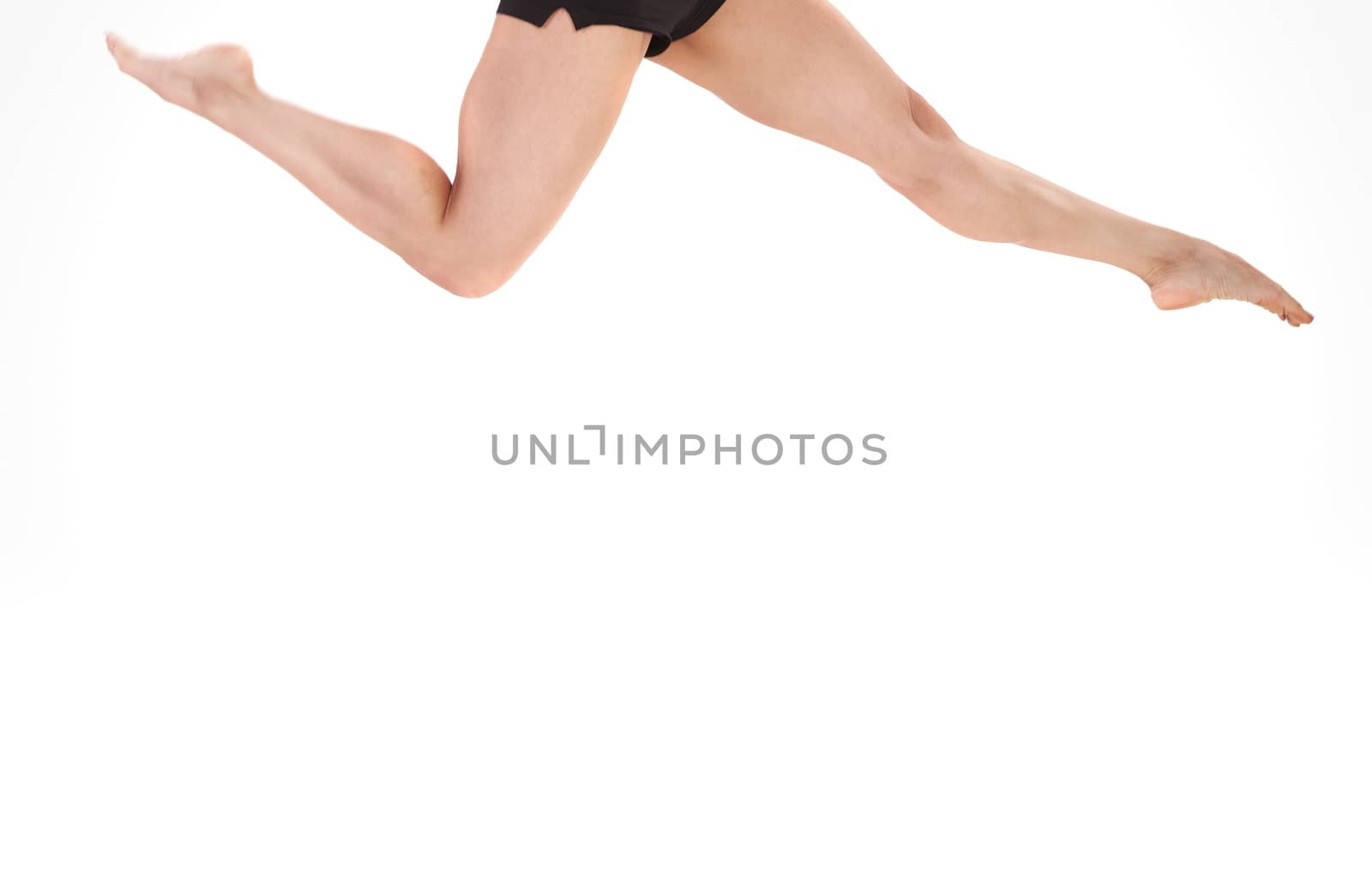 Close-up view on egs of the woman jumping on a white background