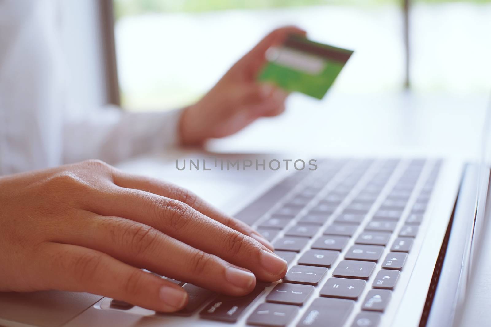 Business Woman Hands holding plastic credit card and using laptop smart phone Online shopping concept